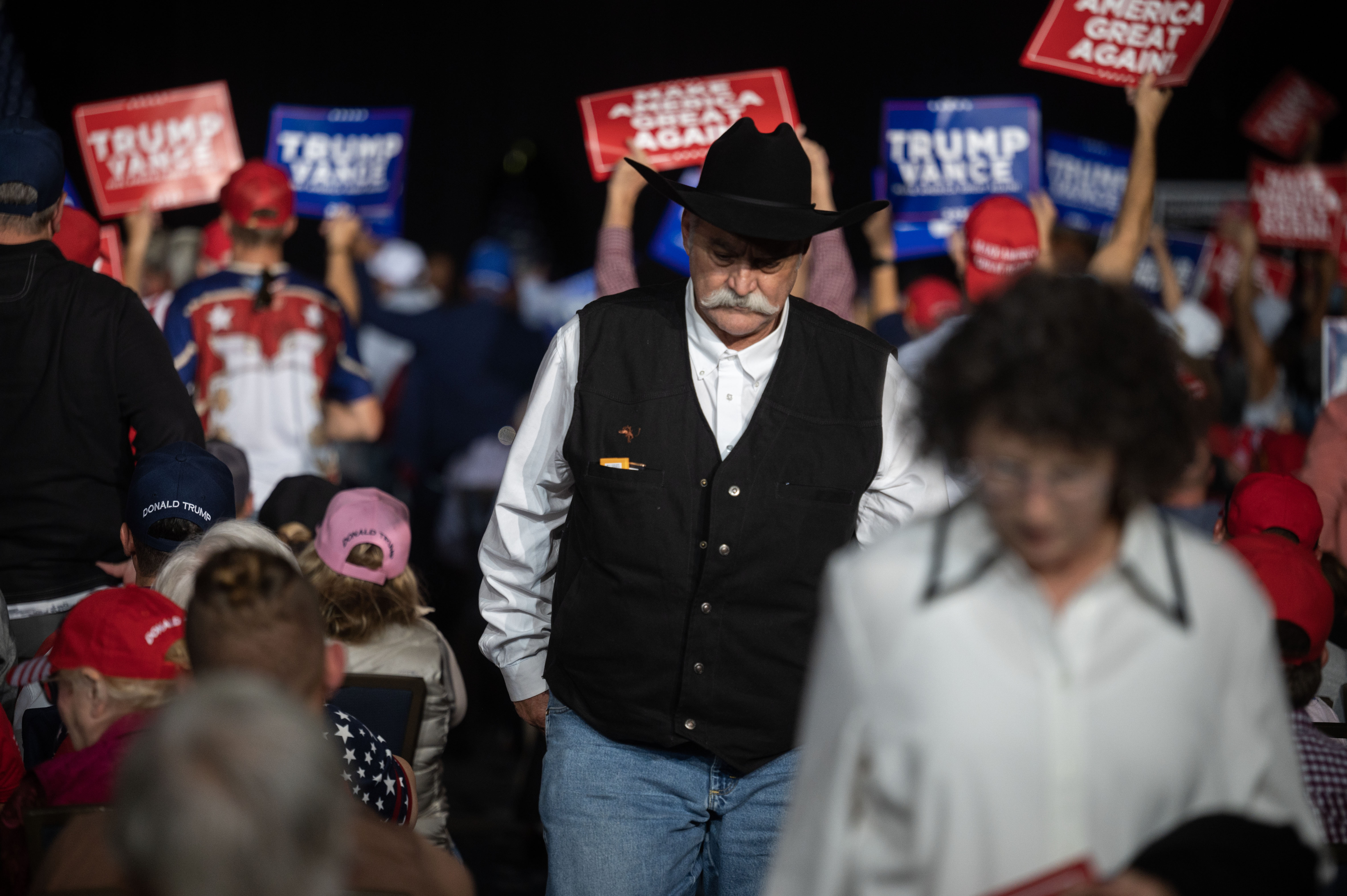 People walk through the crowd on their way out of the convention center during a trump rally at the Gaylord Rockies Resort and Convention Center in Aurora on Friday, Oct. 11, 2024. (Stephen Swofford, Denver Gazette) (Stephen Swofford Denver Gazette)