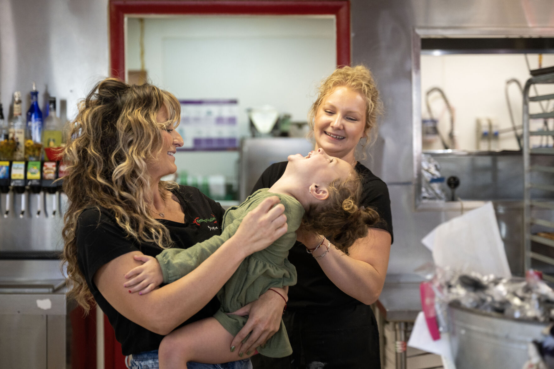 Joeylyn Corder, left, holds her niece, Ellie Jo, 4, as her mom, Kylie tickles her behind the counter at Grammy’s Goodies in Wheat Ridge on Thursday, Oct. 3. (StephenSwoffordPhotographerstephen.swofford@gazette.comhttps://secure.gravatar.com/avatar/1ddcaf11c5d70eaa58546ddc4e038687?d=mm&r=g)