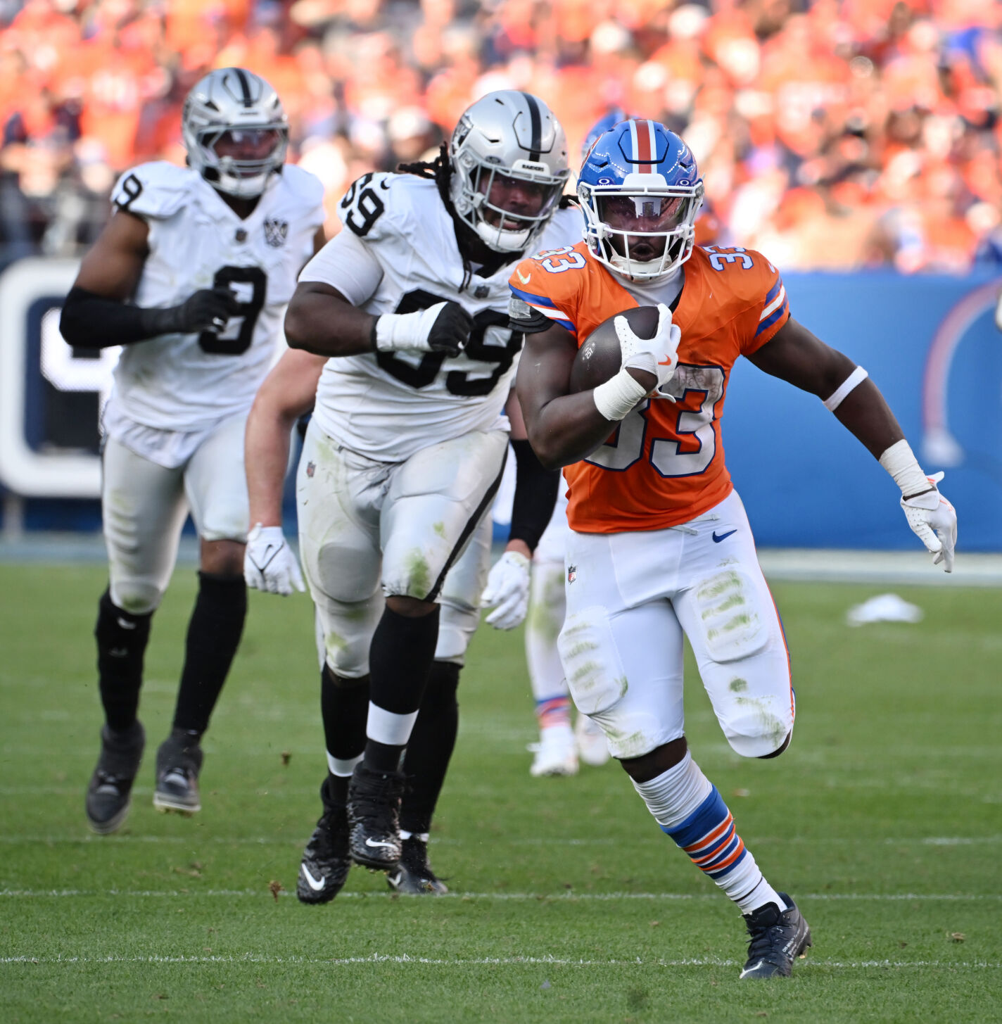 Denver Broncos running back Javonte Williams (33) is chased down the field by Raiders during the fourth quarter of a game at Empower Field at Mile High on Sunday, Oct. 6, 2024. The Broncos won the game 34-18. (Jerilee Bennett, The Gazette)