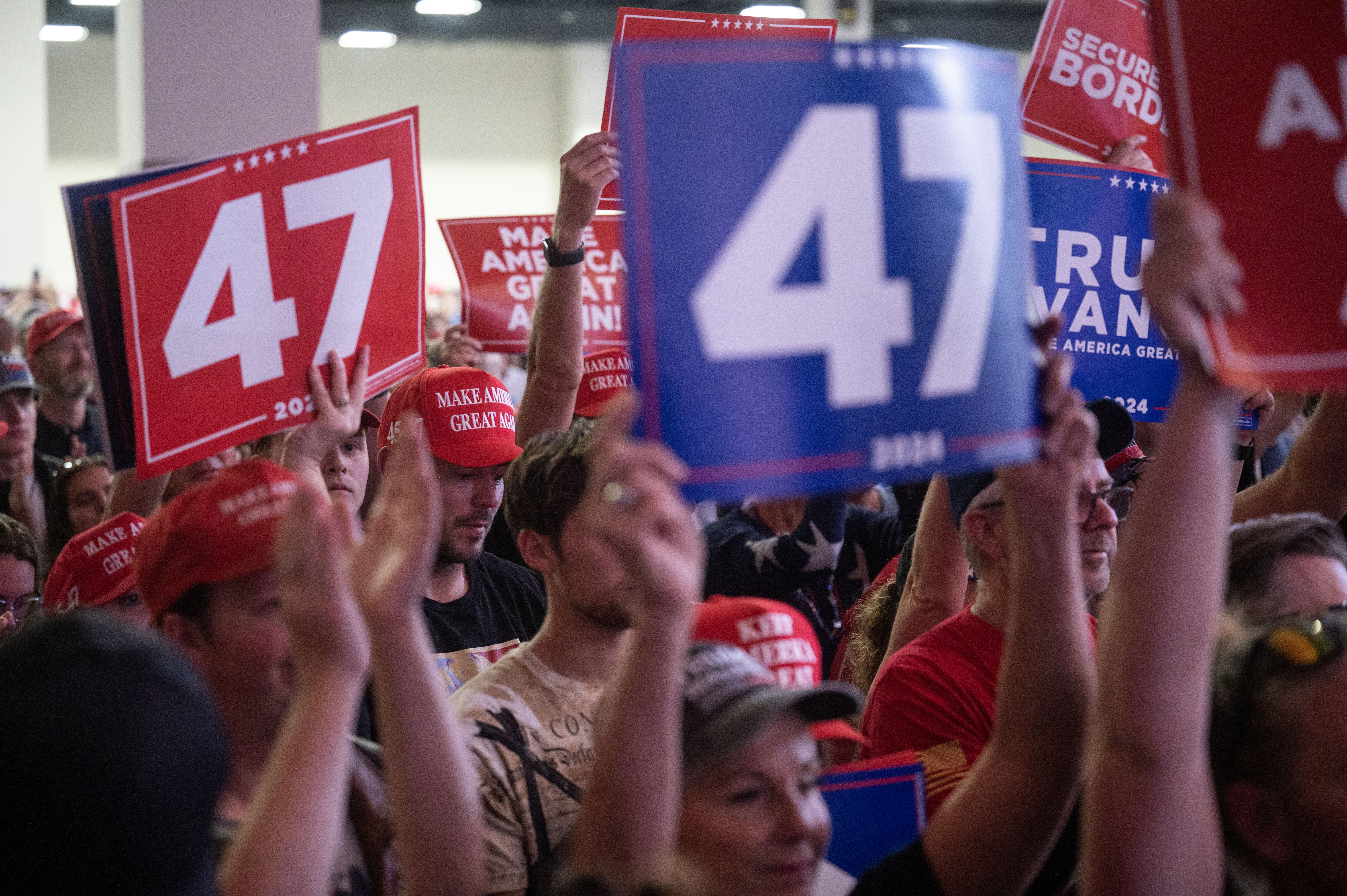 The crowd cheers and waves signs and phones as Trump takes the stage during a political rally at the Gaylord Rockies Resort and Convention Center in Aurora on Friday, Oct. 11, 2024. (Stephen Swofford, Denver Gazette) (Stephen Swofford Denver Gazette)