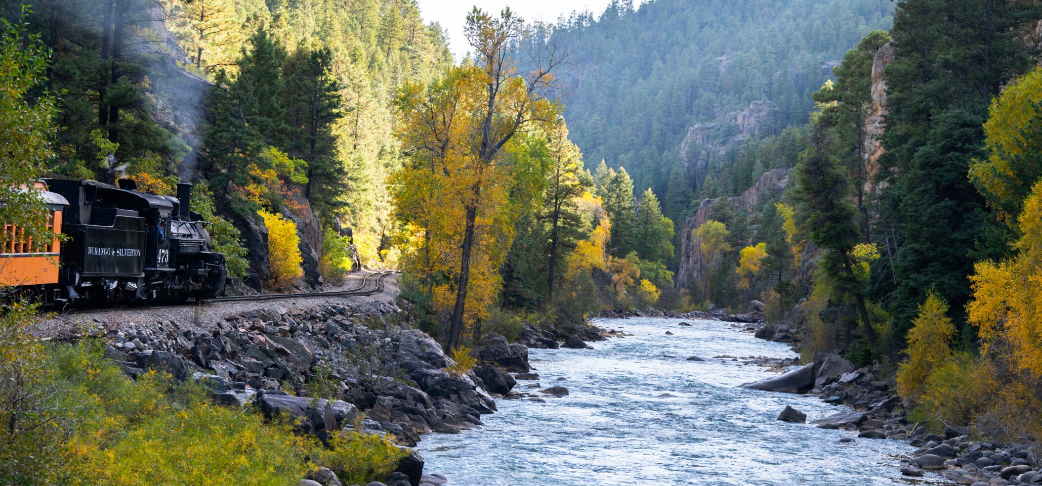 Clockiwse from left: The Durango & Silverton Narrow Gauge Railroad train follows the Animas River shortly after leaving Silverton toward Durango as the sun spotlights the turning trees last month. A large grove of changing aspens creates a bright yellow foreground to the Sawatch Mountain Range last week. The Durango & Silverton Narrow Gauge Railroad steam engine crosses the High Bridge above the Animas River last week as it travels from Silverton to Durango. The train has been transporting passengers from the two Colorado towns since 1882. (Christian Murdock, pikes peak courier)