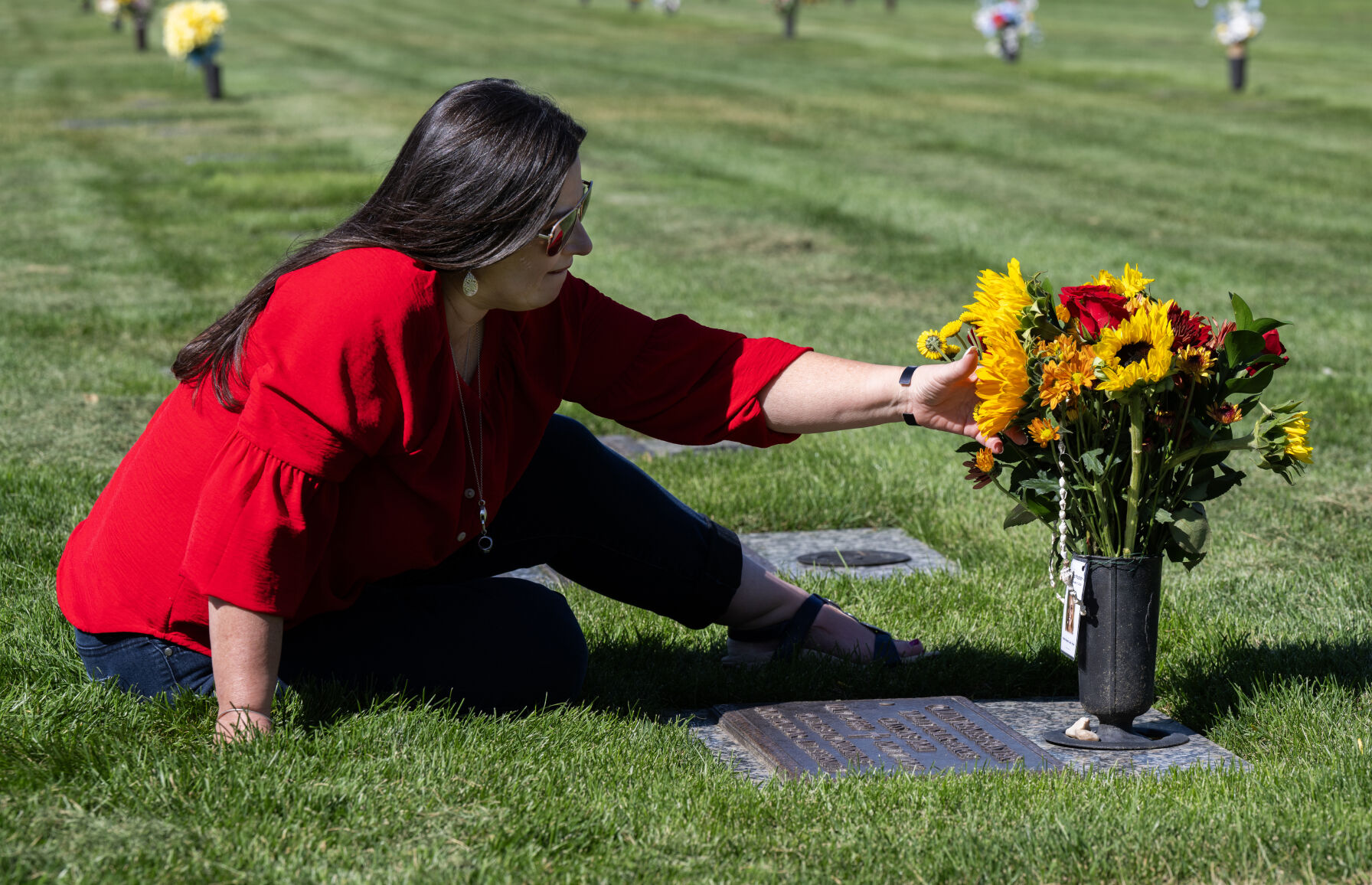 Colleen Foster visits the grave of her daughter, Cailin Foster, at the cemetery at the Air Force Academy last month. Colleen and her husband, retired Air Force Lt. Col. Gary Foster, visit the grave often. (Christian Murdock, The Gazette)