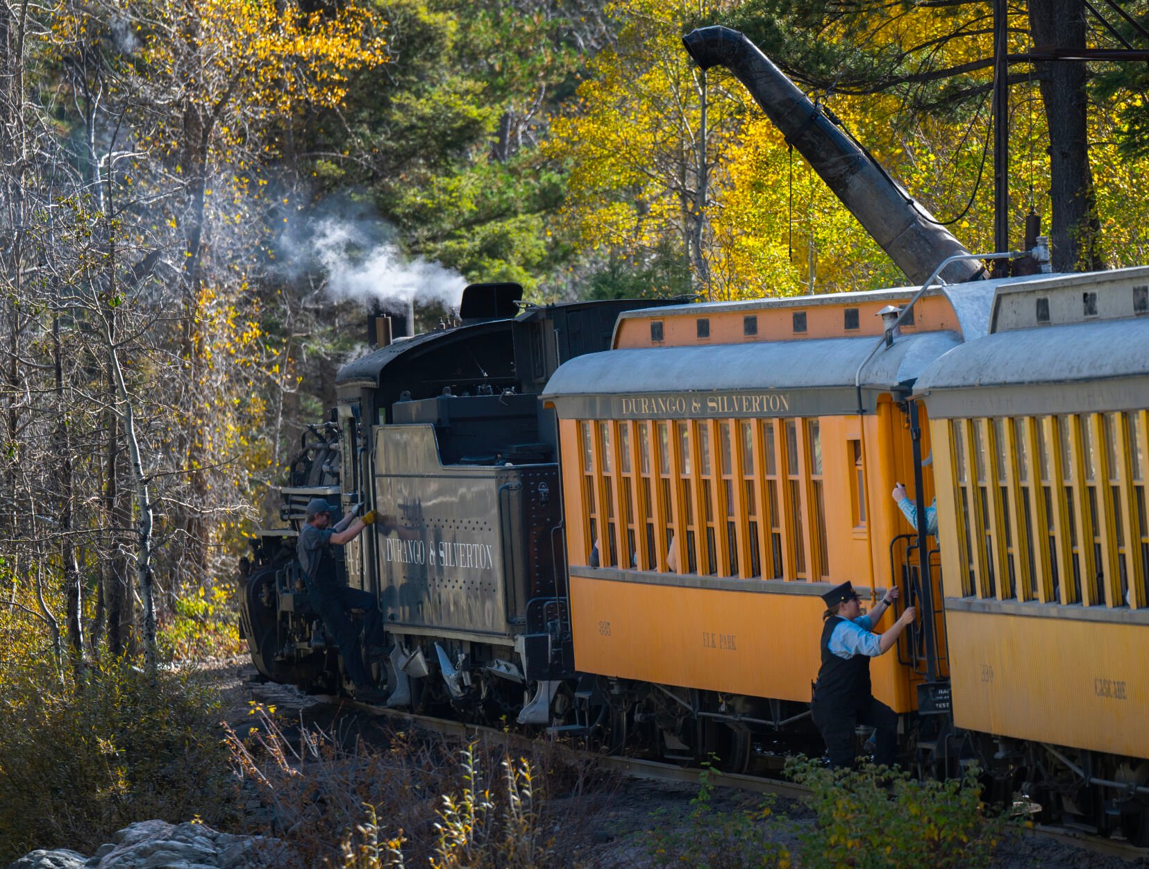 The train crew jumps onboard after stopping at a water station to fill the Durango & Silverton Narrow Gauge steam engine last week between Silverton and Durango. (Christian Murdock, The Gazette)