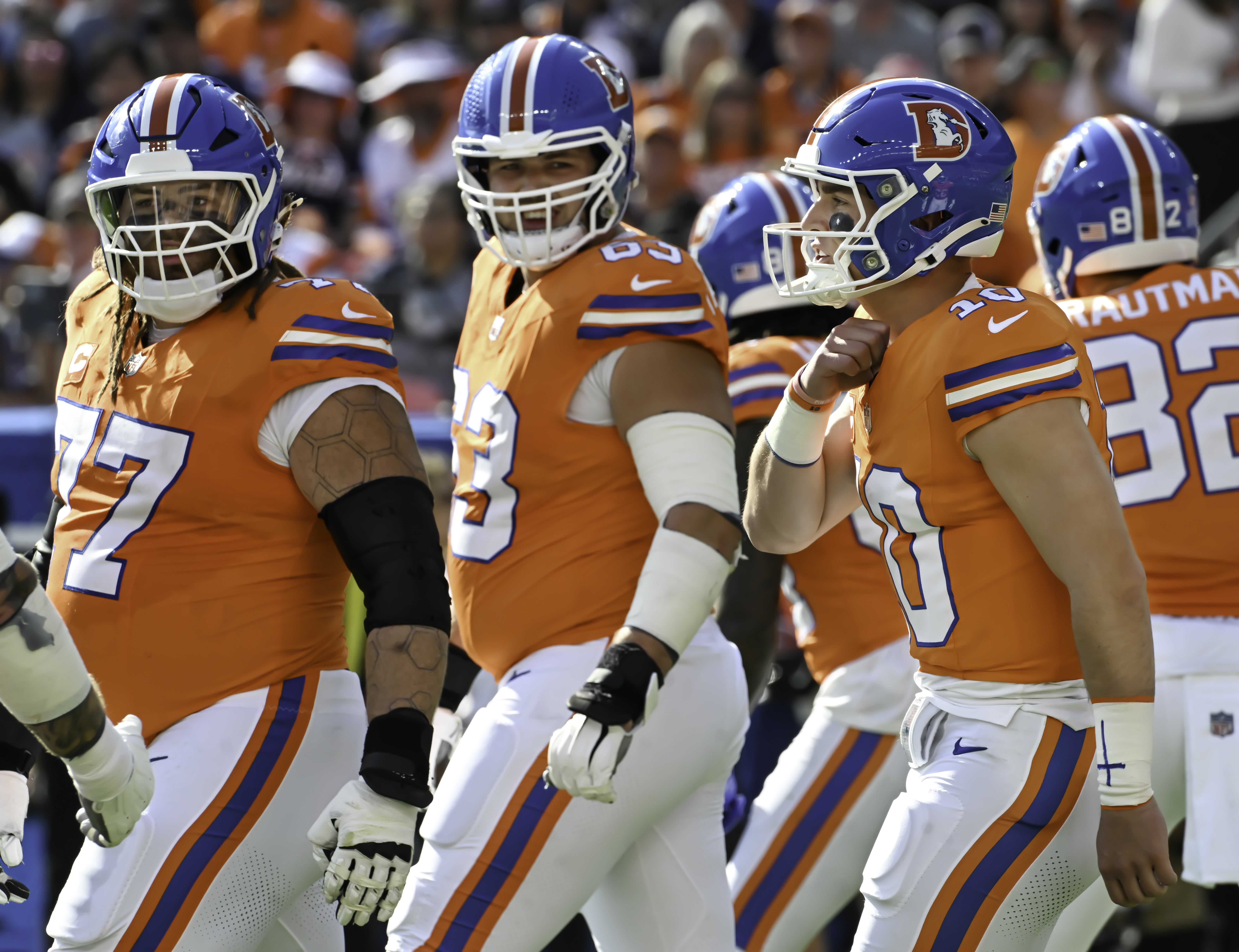 Denver Broncos guard Quinn Meinerz (77) and Denver Broncos offensive tackle Alex Palczewski (63) look around to take direction from Denver Broncos quarterback Bo Nix (10) during a game against the Raiders at Empower Field at Mile High on Sunday, Oct. 6, 2024.