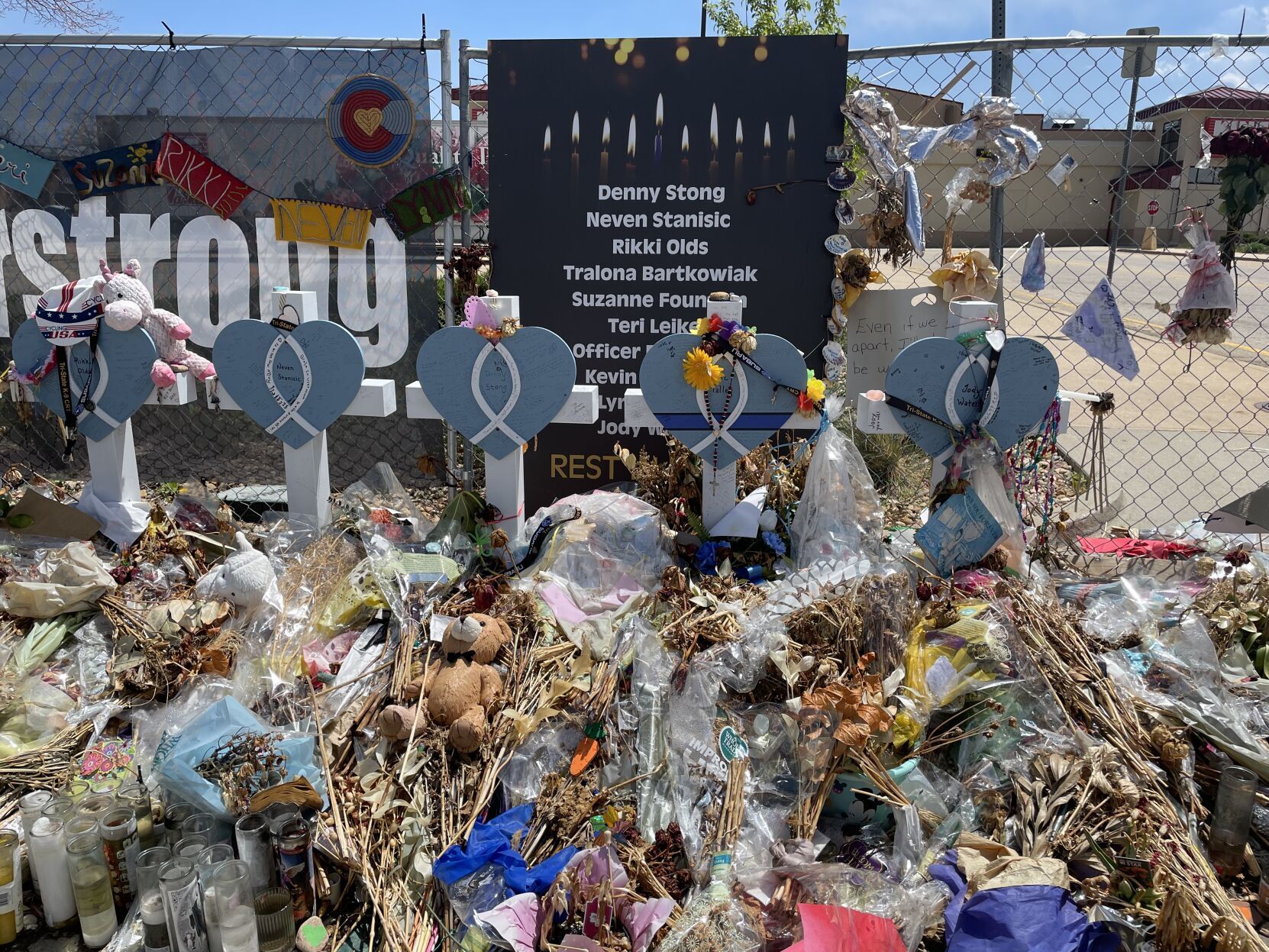 Messages of remembrance, withered flowers and prayer flags lean against the fence set up around the Boulder King Soopers where a gunman killed 10 people. (JuliaCardiGeneral Assignment Reporterjulia.cardi@gazette.comhttps://secure.gravatar.com/avatar/3e548b6a43ff4b815b2d170f62f00495?d=mm&r=g)