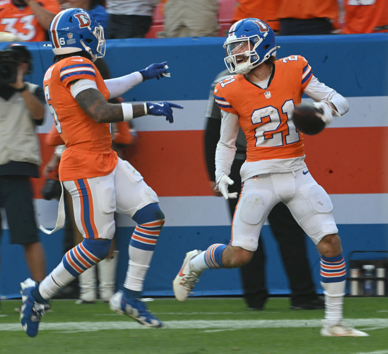 Denver Broncos cornerback Riley Moss (21) celebrates on his way to the end zone as he is escorted down the field by teammates after making an interception for a pick six during the fourth quarter of a game at Empower Field at Mile High on Sunday, Oct. 6, 2024. The Broncos won the game 34-18. (Jerilee Bennett, The Gazette)