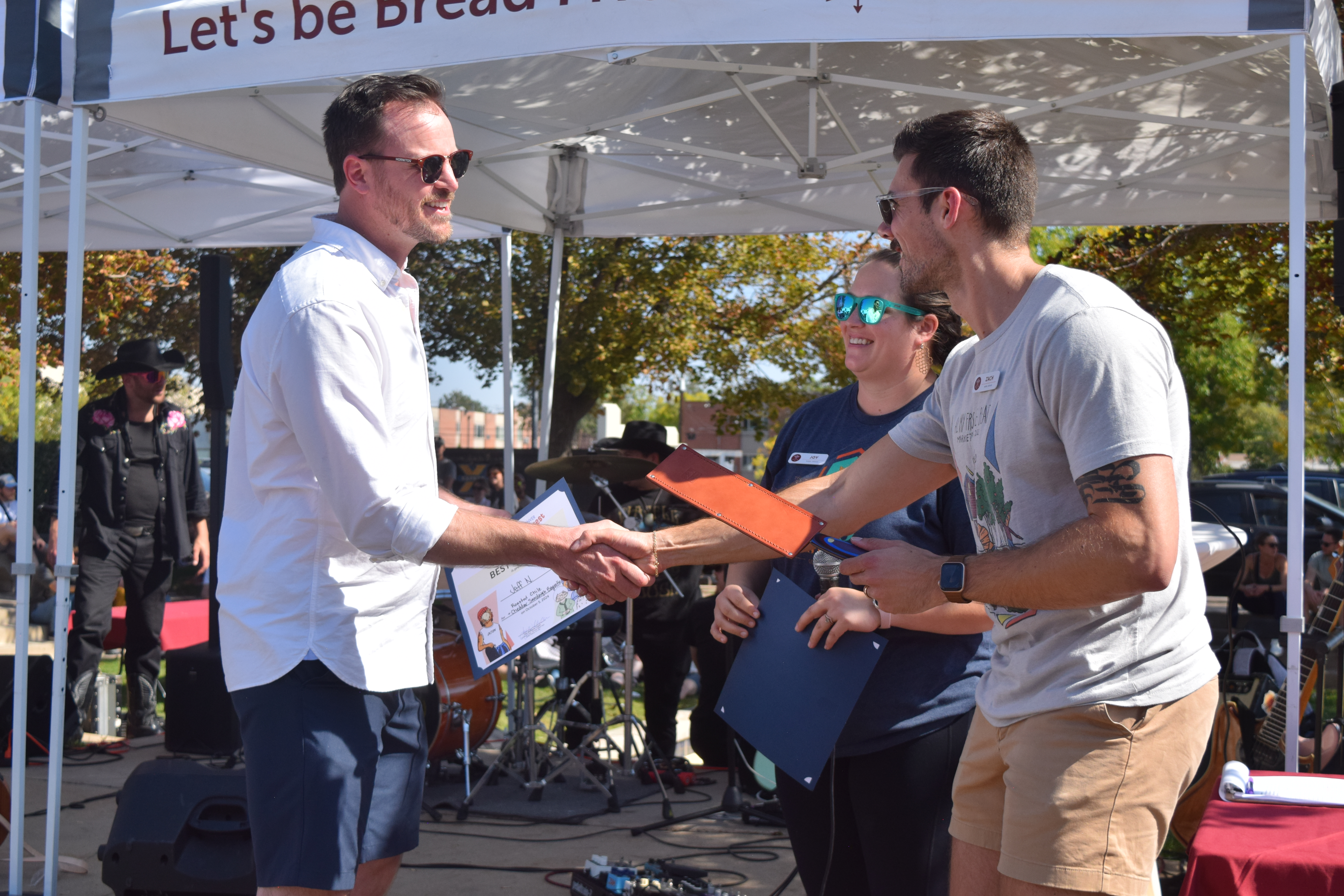 Jeff Nixon, left, shakes the hand of Rebel Bread owner Zach Martinucci on Saturday after winning the award for best in show at the Denver Bake Fest. That makes Nixon's third award over the last two festivals, despite starting baking in 2020. (SageKelleyJefferson County Reportersage.kelley@denvergazette.comhttps://denvergazette.com/content/tncms/avatars/e/5f/457/e5f45740-2717-11ee-85b2-ab80f2d36252.5b966c1d2ce4987987665d57c237eda4.png)