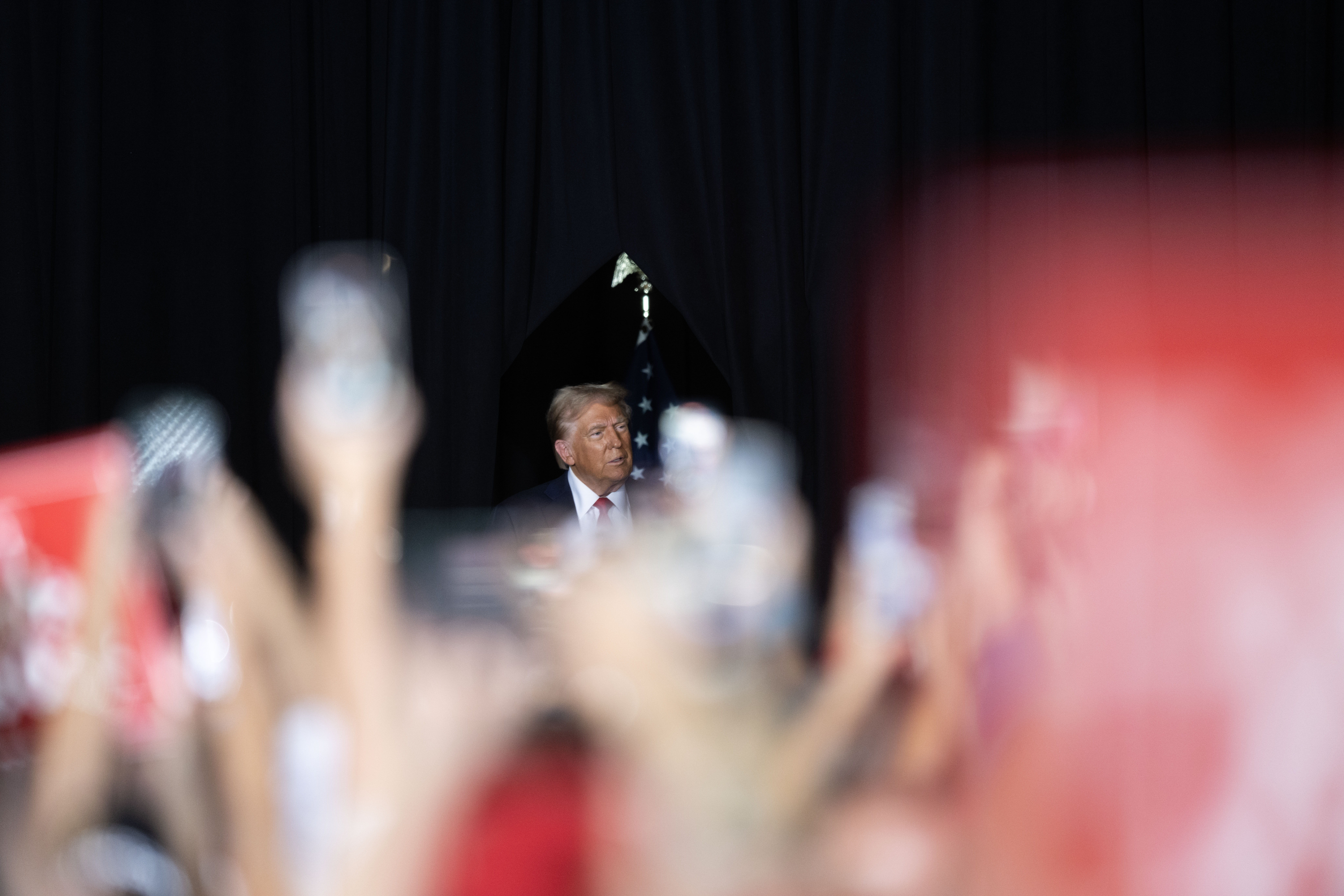 The crowd cheers and waves signs and phones as Trump takes the stage during a political rally at the Gaylord Rockies Resort and Convention Center in Aurora on Friday, Oct. 11, 2024. (Stephen Swofford, Denver Gazette) (Stephen Swofford Denver Gazette)
