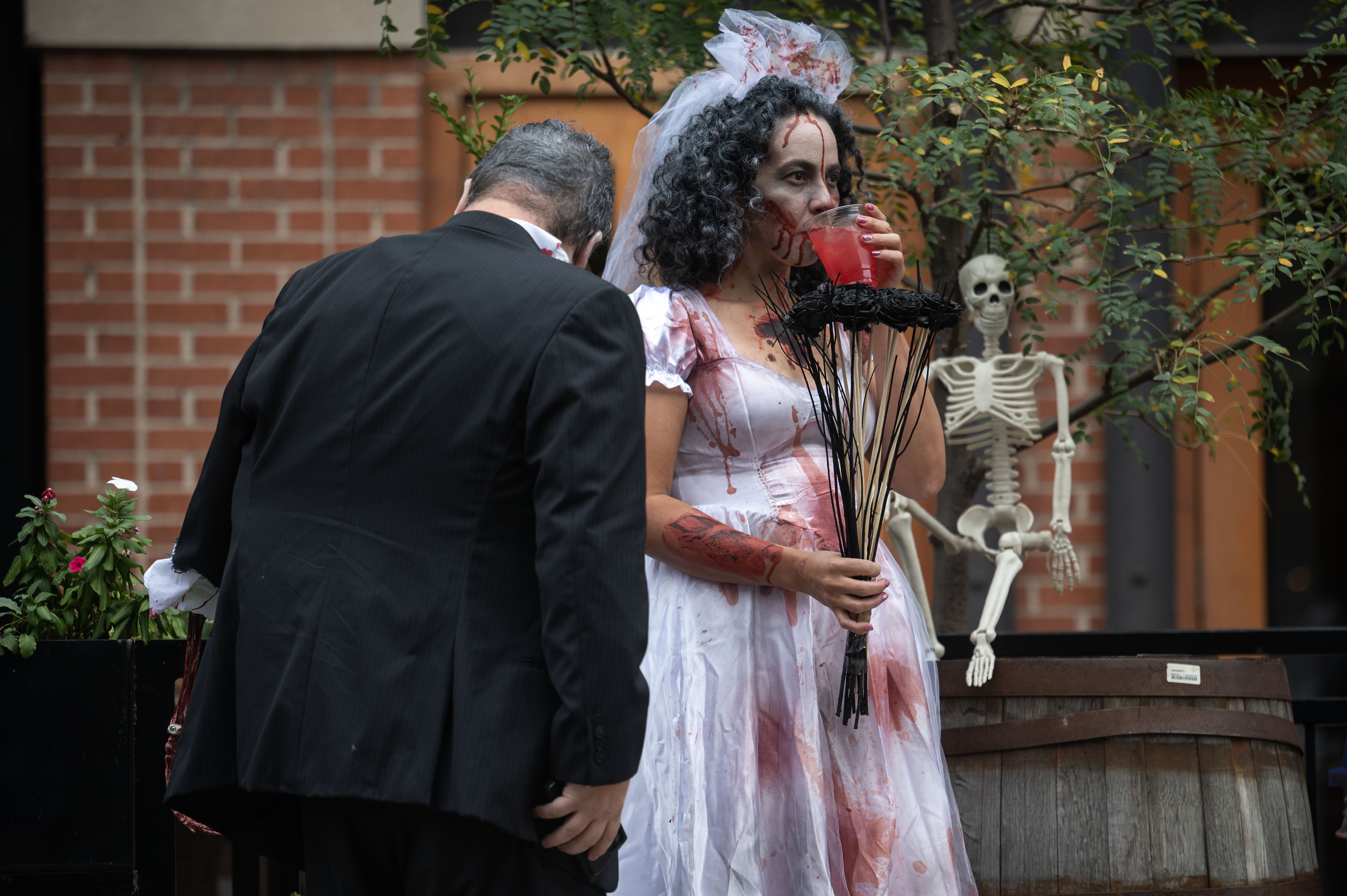 Jon Mesick and his fiancée Mili Cuellar have a drink as they walk through Larimer Square during the Denver Zombie Crawl on Saturday, Oct. 19, 2024. (Stephen Swofford, Denver Gazette) (StephenSwoffordPhotographerstephen.swofford@gazette.comhttps://secure.gravatar.com/avatar/1ddcaf11c5d70eaa58546ddc4e038687?d=mm&r=g)