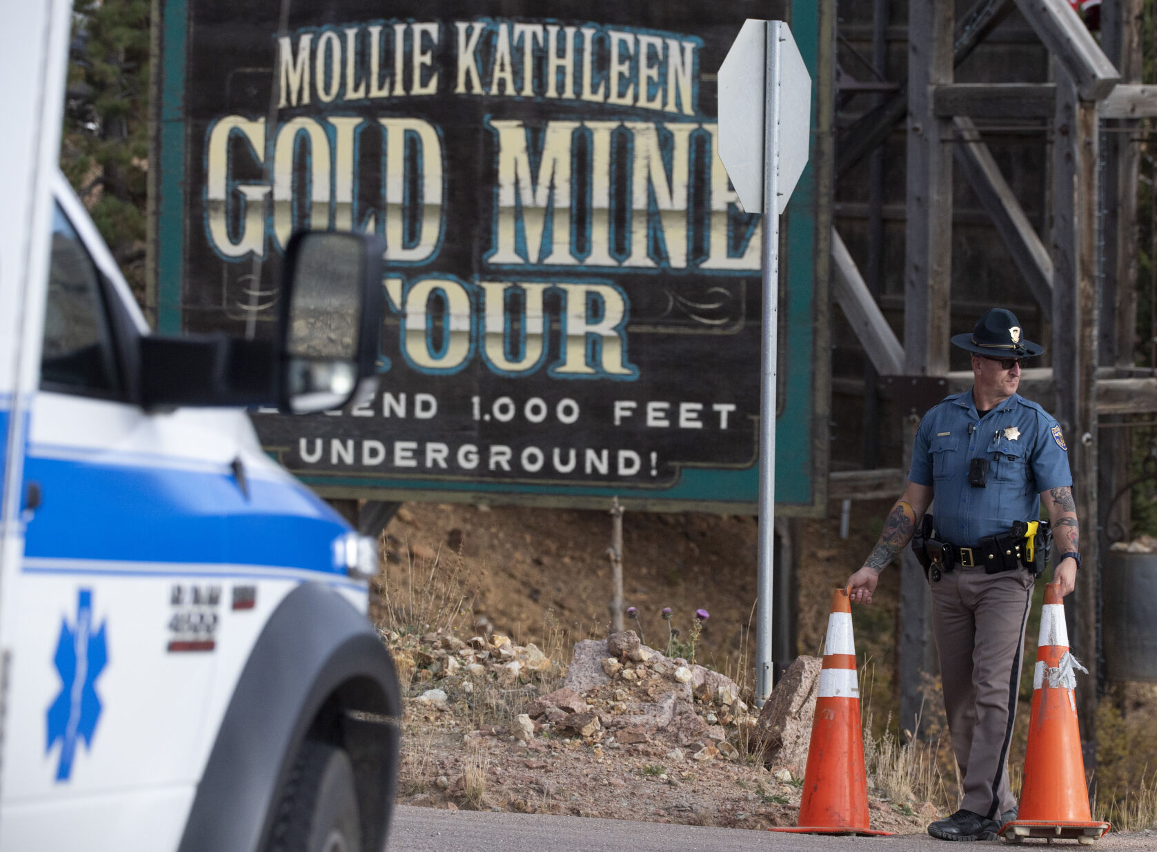 A police officer moves a barrier for an emergency vehicle Thursday, Oct. 10 at Mollie Kathleen Gold Mine in Cripple Creek. (Arthur H. Trickett-Wile, the gazette)