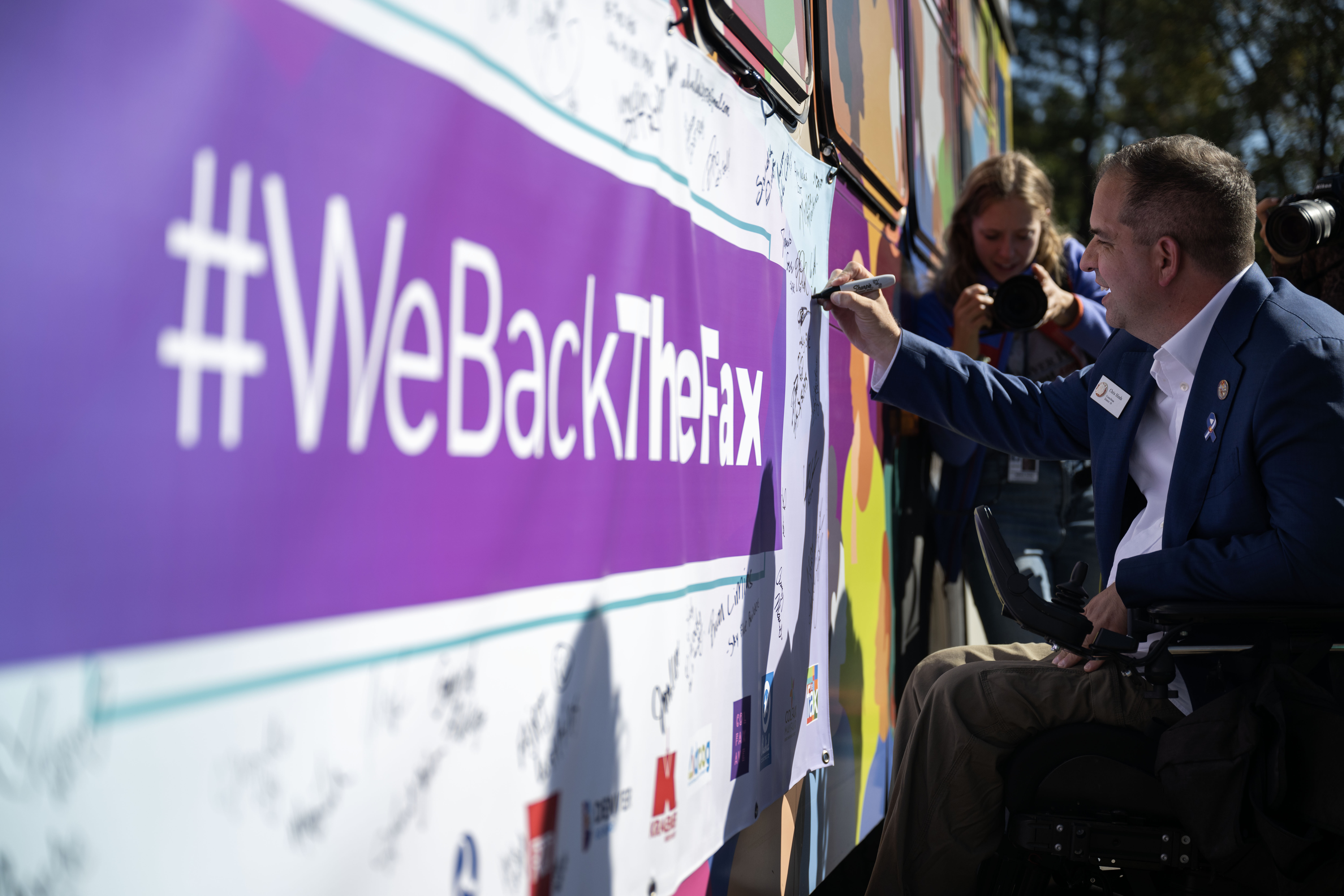 Denver City Councilmember Chris Hinds signs a banner on the side of a bus during the groundbreaking ceremony on Friday, Oct. 4, 2024 for a $280 million project that will introduce Denver’s first bus rapid transit aimed at transforming how bus service operates on East Colfax Avenue. (Stephen Swofford, Denver Gazette) (StephenSwoffordPhotographerstephen.swofford@gazette.comhttps://secure.gravatar.com/avatar/1ddcaf11c5d70eaa58546ddc4e038687?d=mm&r=g)