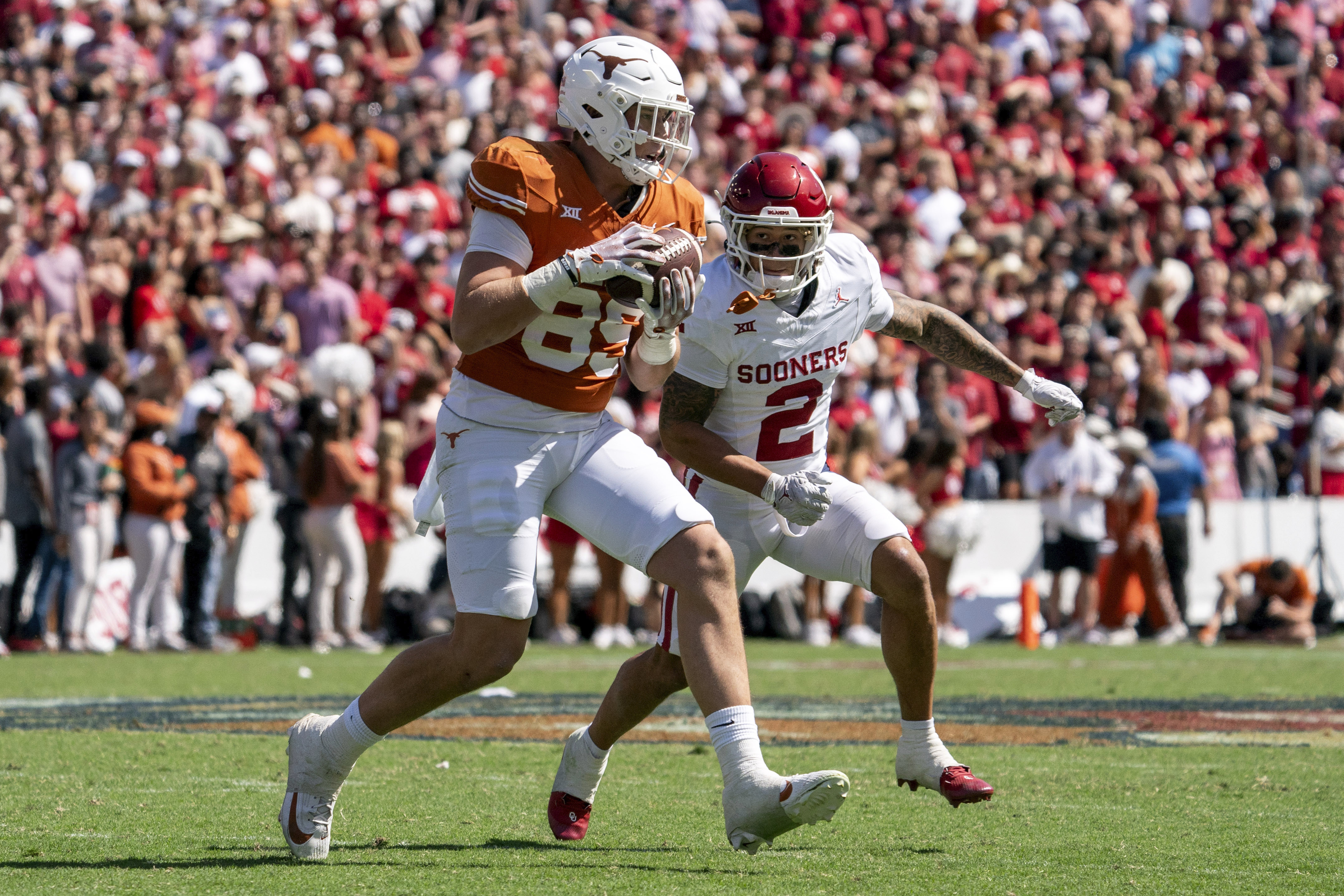 Texas tight end Gunnar Helm (85) makes a catch as Oklahoma defensive back Billy Bowman Jr. (2) closes in for the tackle during an NCAA college football game at the Cotton Bowl, Saturday, Oct. 7, 2023, in Dallas. Oklahoma won 34-30. (AP Photo/Jeffrey McWhorter) (Jeffrey McWhorter)
