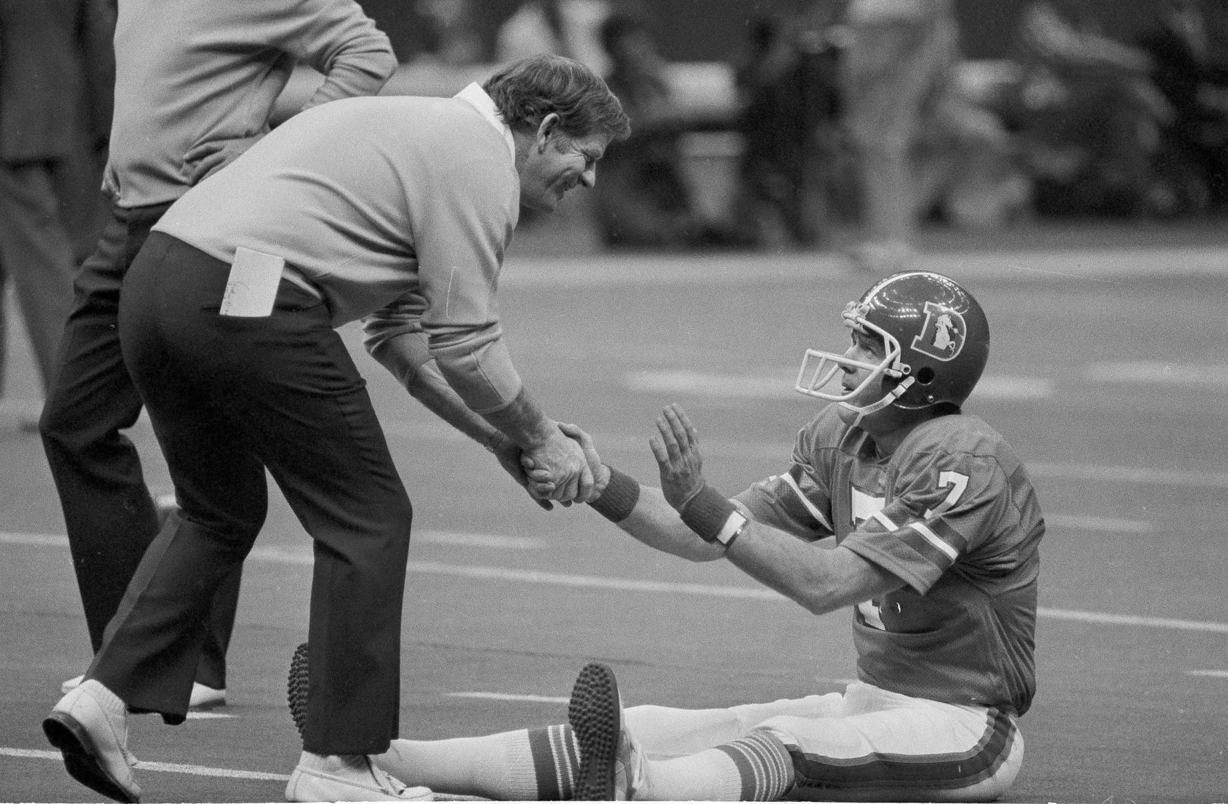 In this Jan. 15, 1978, file photo, Red Miller, coach of the Broncos, shakes hands with his quarterback, Craig Morton, during the team's warm-ups before Super Bowl XII against the Dallas Cowboys in New Orleans. (AP Photo/File) (The AP)
