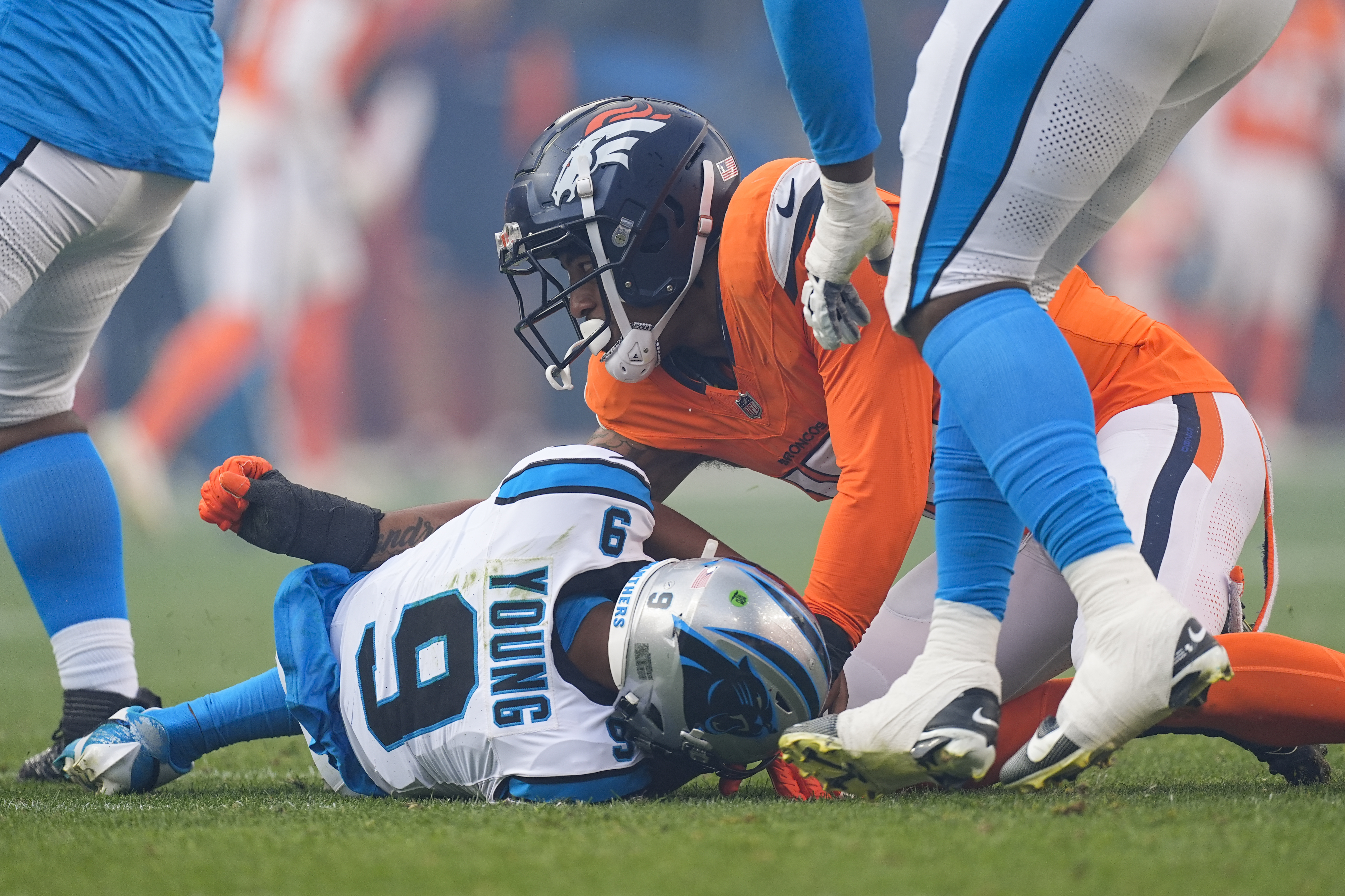 Denver Broncos linebacker Nik Bonitto, top, sacks Carolina Panthers quarterback Bryce Young (9) during the second half of an NFL football game Sunday, Oct. 27, 2024, in Denver. (AP Photo/David Zalubowski) (David Zalubowski)