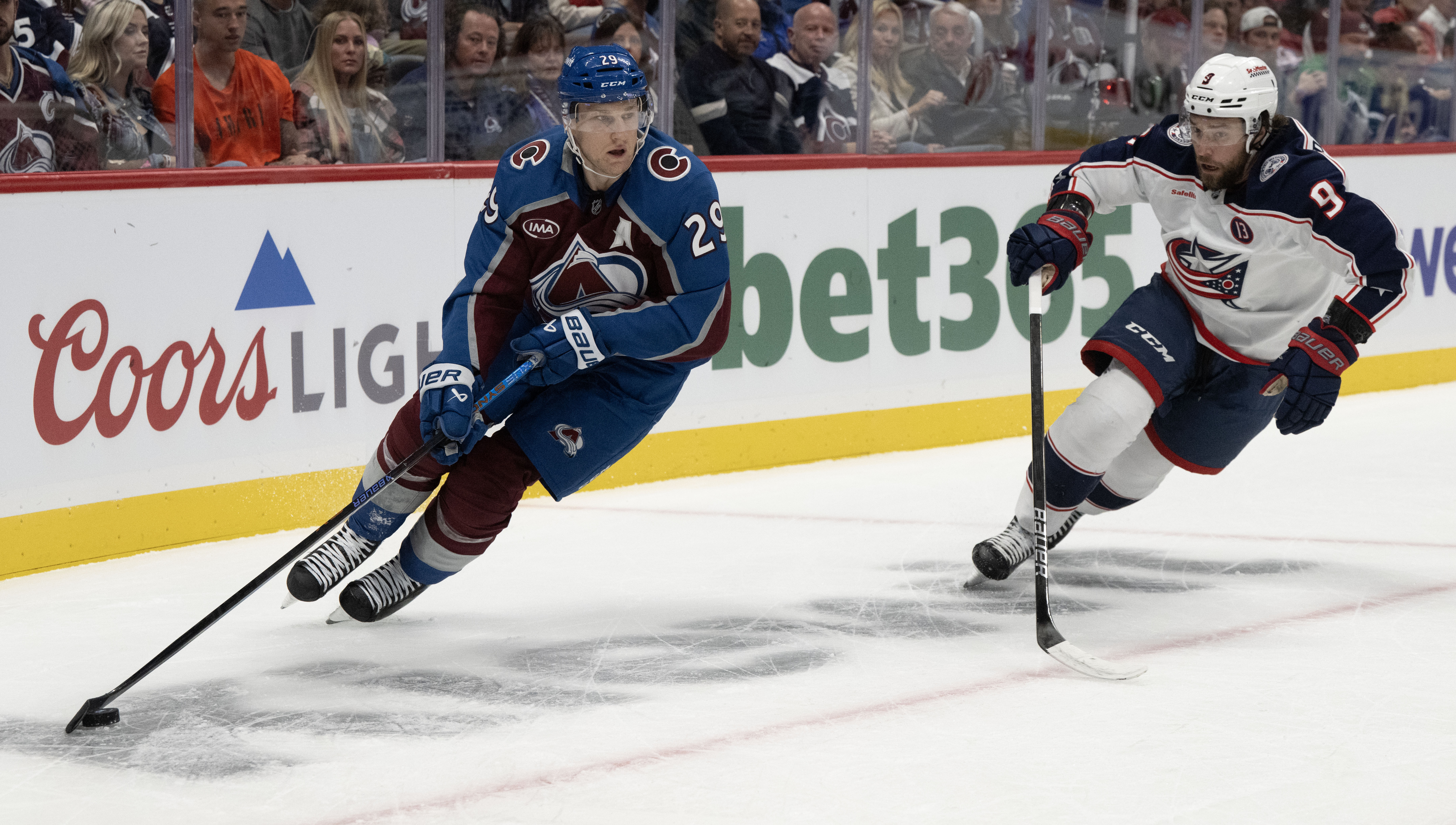 Colorado Avalanche center Nathan MacKinnon (29) moves the puck behind the Columbus Blue Jackets goal as Columbus Blue Jackets defenseman Ivan Provorov (9) defends during the first period Saturday, Oct. 12, 2024, at Ball Arena in Denver. (AP Photo/The Gazette, Christian Murdock) (Christian Murdock)