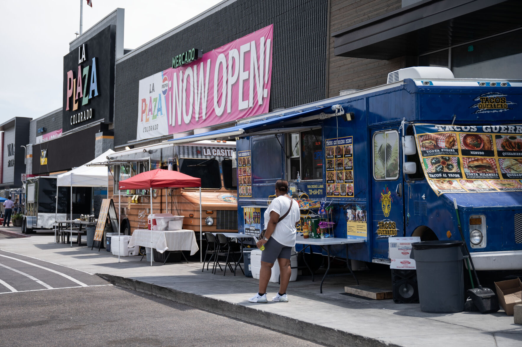 People eat lunch from food trucks outside the newly opened La Plaza in Denver on Friday, July 19, 2024. (Stephen Swofford, Denver Gazette) (StephenSwoffordPhotographerstephen.swofford@gazette.comhttps://secure.gravatar.com/avatar/1ddcaf11c5d70eaa58546ddc4e038687?d=mm&r=g)