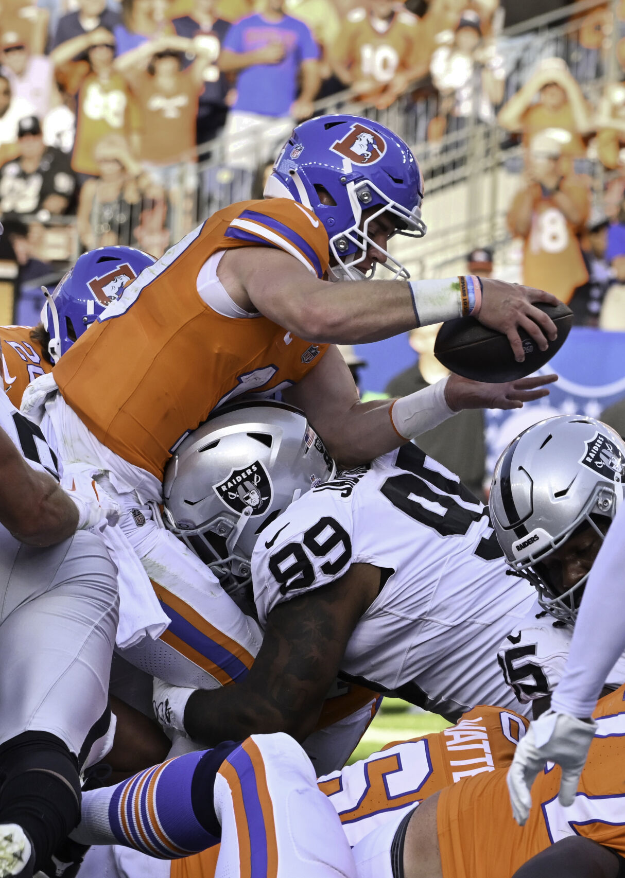 Broncos quarterback Bo Nix goes up over the top for a touchdown in the 4th quarter of a game against the Raiders at Empower Field at Mile High on Sunday, Oct. 6, 2024. The Broncos won the game 34-18. (Jerilee Bennett, The Gazette)