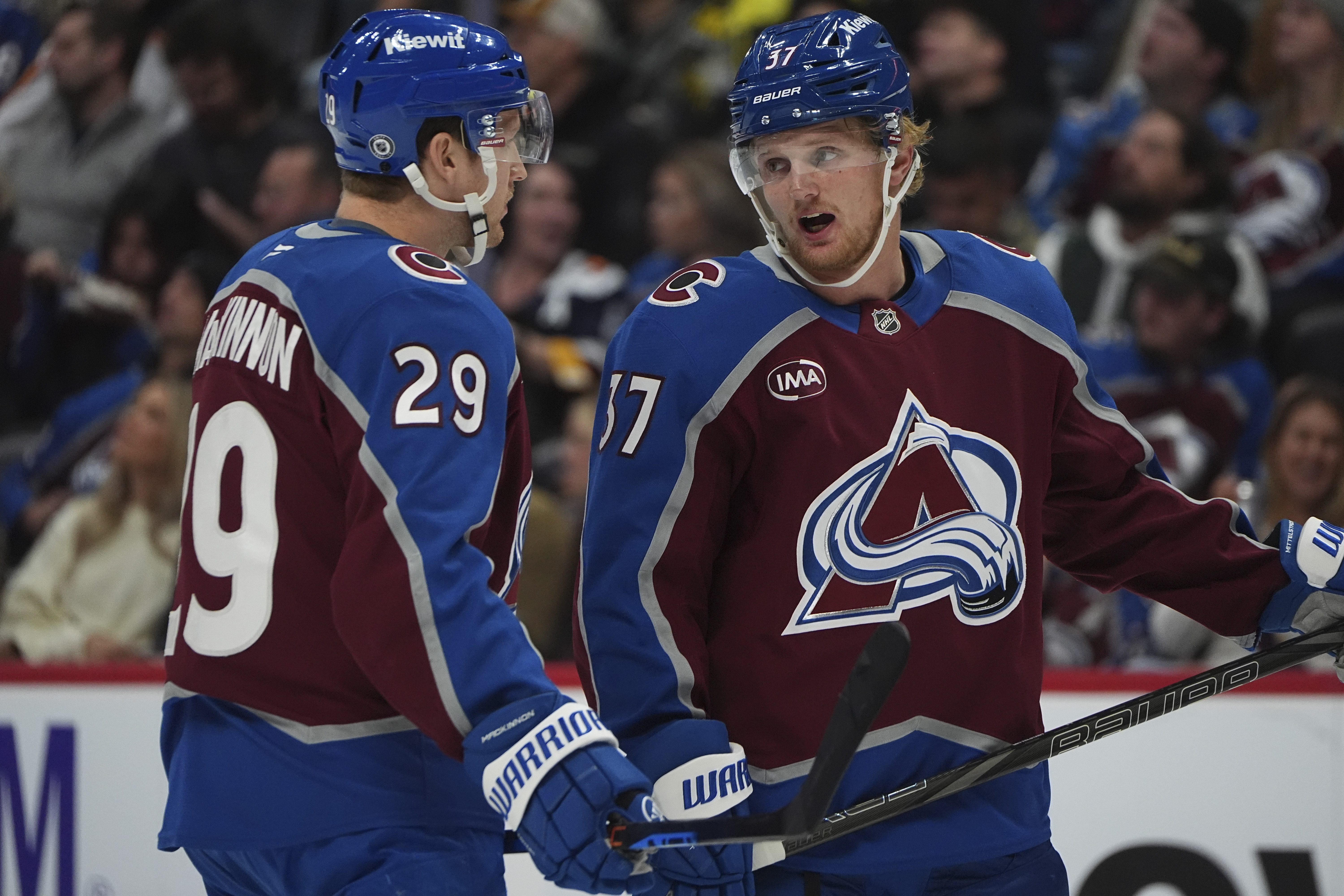 Colorado Avalanche center Nathan MacKinnon (29) confers with Colorado Avalanche center Casey Mittelstadt (37) in the first period of an NHL hockey game Wednesday, Nov. 13, 2024, in Denver. (AP Photo/David Zalubowski) (David Zalubowski)