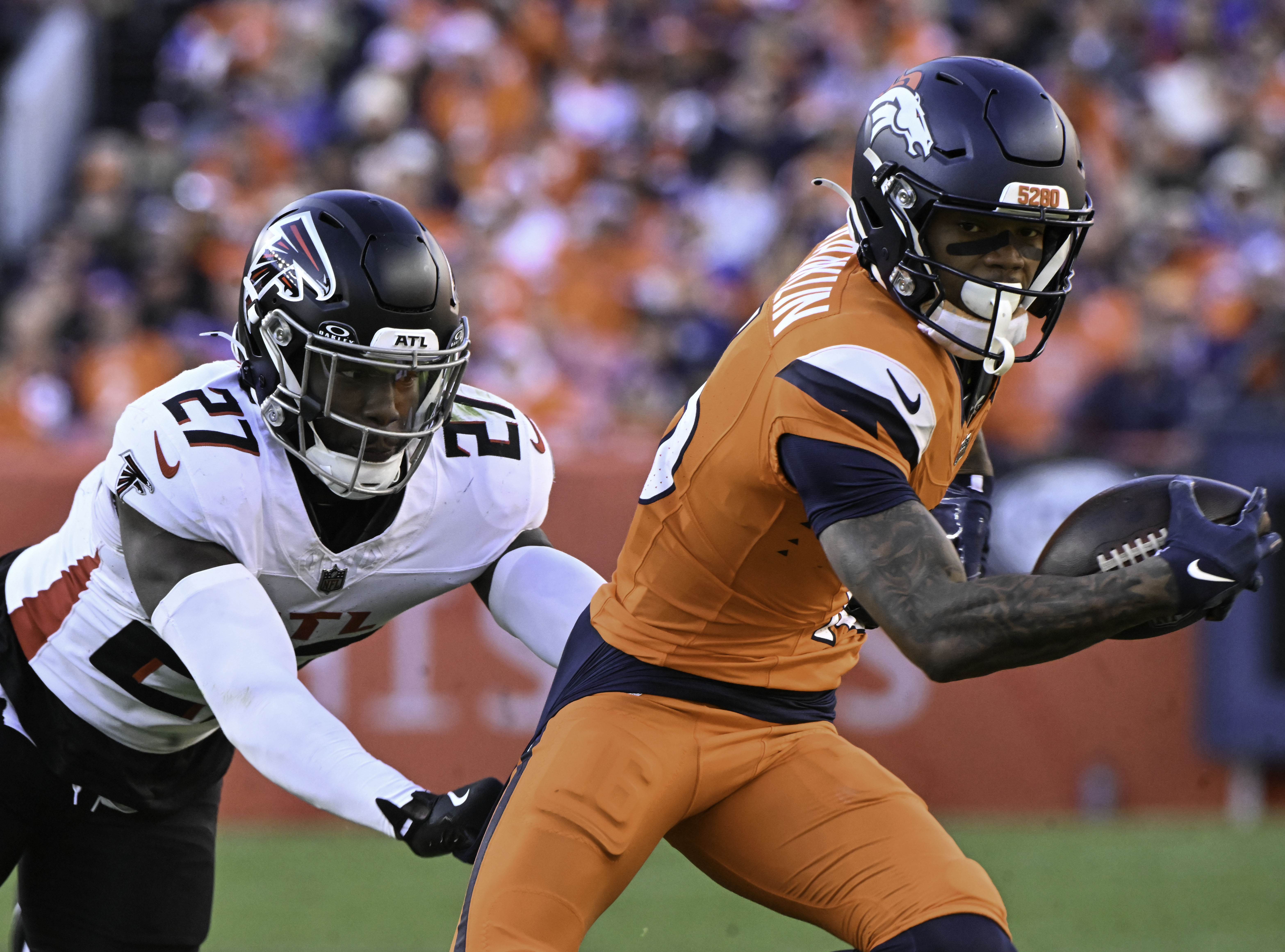 Denver Broncos wide receiver Troy Franklin (16) is pursued by Atlanta Falcons safety Richie Grant (27) during the second quarter of a game at Empower Field at Mile High on Sunday, Nov. 17, 2024. The Broncos defeated the Falcons 38-6. (Jerilee Bennett,The Gazette)