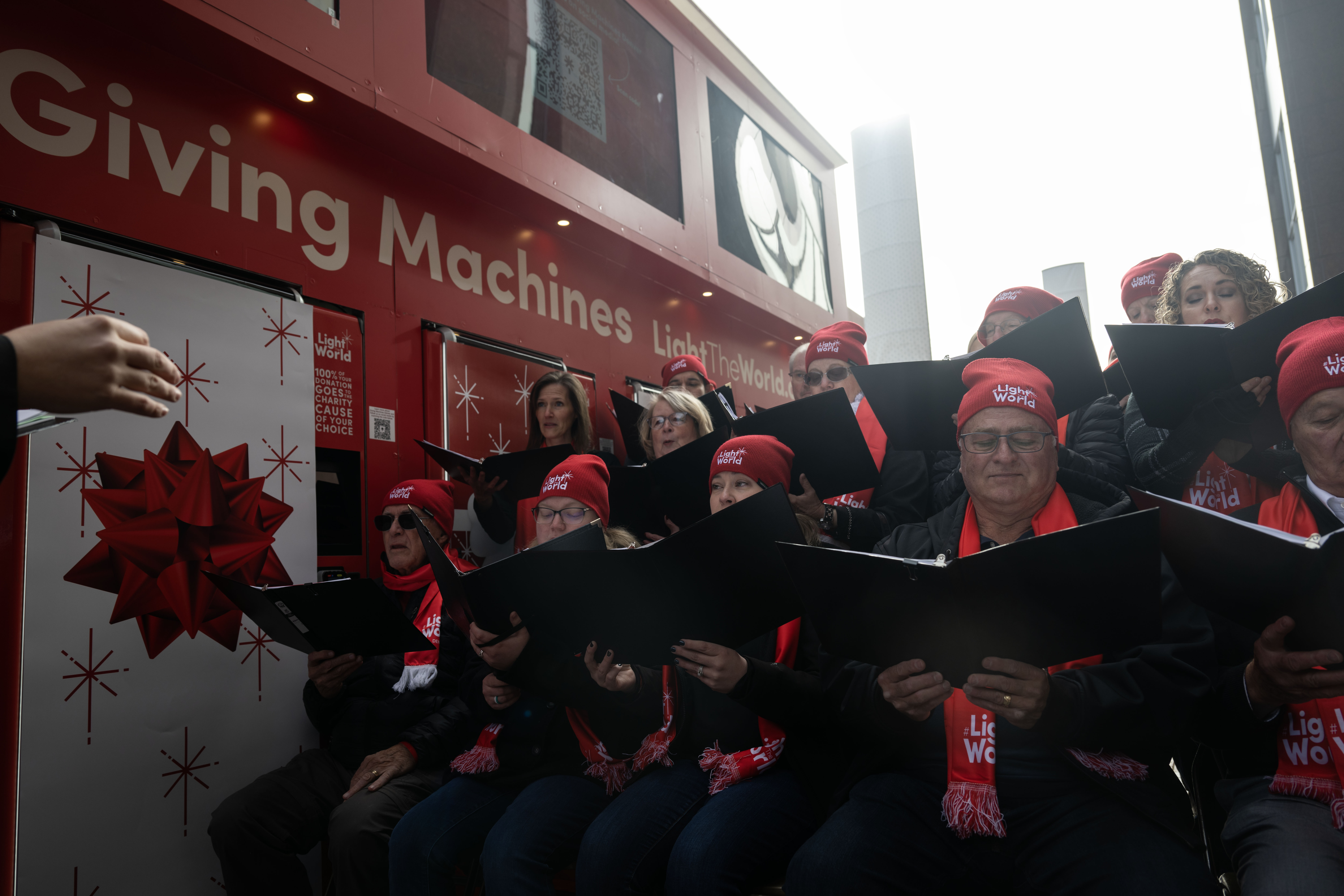 Members of a holiday chorus perform during an unwrapping event for Giving Machines in Cherry Creek North on Thursday, Nov. 21, 2024. The giving machines are customized vending machines that allow you to donate directly to one of five local/Denver-metro charities or two global charities. (Stephen Swofford, Denver Gazette) (StephenSwoffordPhotographerstephen.swofford@gazette.comhttps://secure.gravatar.com/avatar/1ddcaf11c5d70eaa58546ddc4e038687?d=mm&r=g)