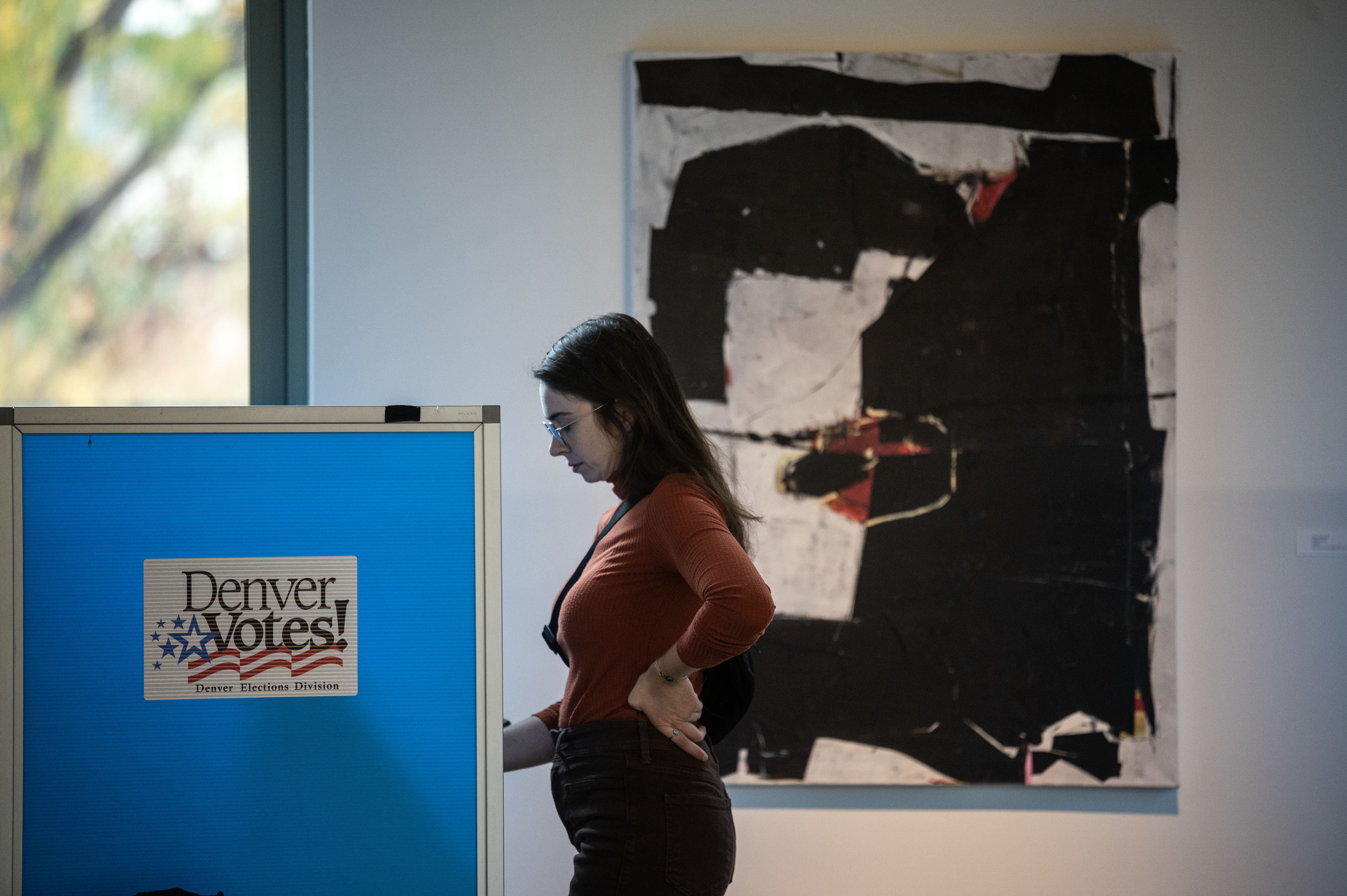 Kelly Giuliani fills out her ballot at a polling center in the McNichols building in Denver on Monday, Nov. 4, 2024. (Stephen Swofford, Denver Gazette) (Stephen Swofford Denver Gazette)