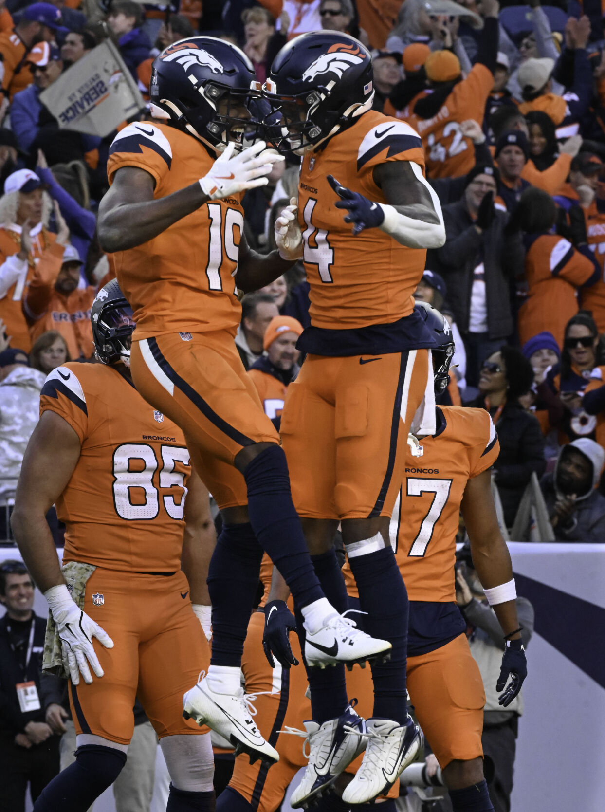 Denver Broncos wide receiver Marvin Mims Jr. (19) celebrates with Denver Broncos wide receiver Courtland Sutton (14) after Mims scored a touchdown during the second quarter of a game at Empower Field at Mile High on Sunday, Nov. 17, 2024. The Broncos defeated the Falcons 38-6. (Jerilee Bennett,The Gazette)