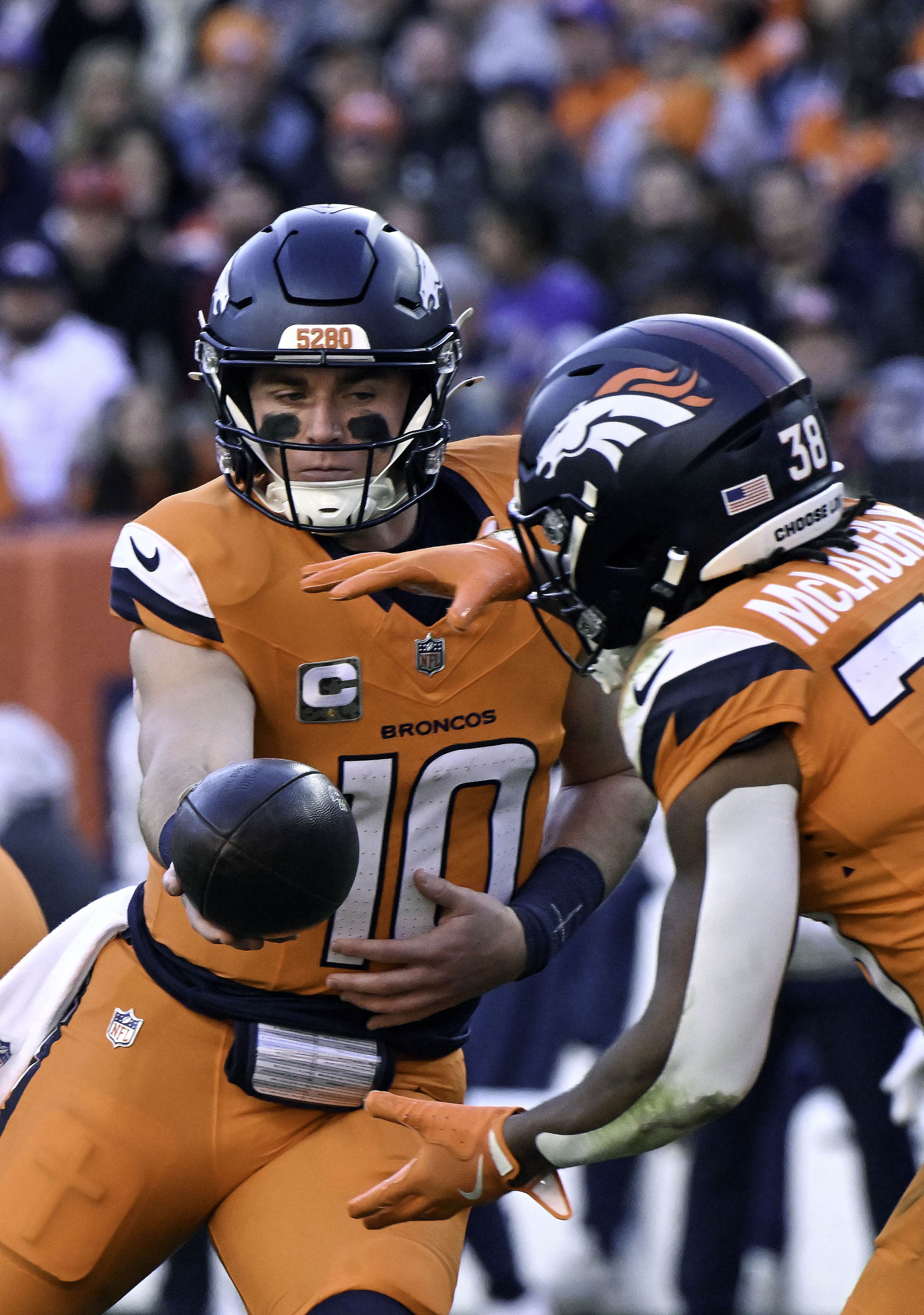 Denver Broncos quarterback Bo Nix (10) hands off the ball to Denver Broncos running back Jaleel McLaughlin (38) during the first quarter of a game at Empower Field at Mile High on Sunday, Nov. 17, 2024. The Broncos defeated the Falcons 38-6. (Jerilee Bennett,The Gazette)