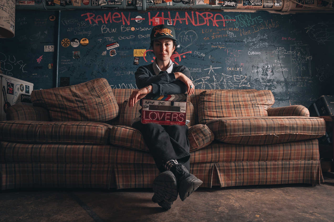 Denver filmmaker Taylor McFadden is shown sitting on the well-worn couch in the green room at the hi-dive, a legendary Denver music venue that's also where McFadden filmed her movie