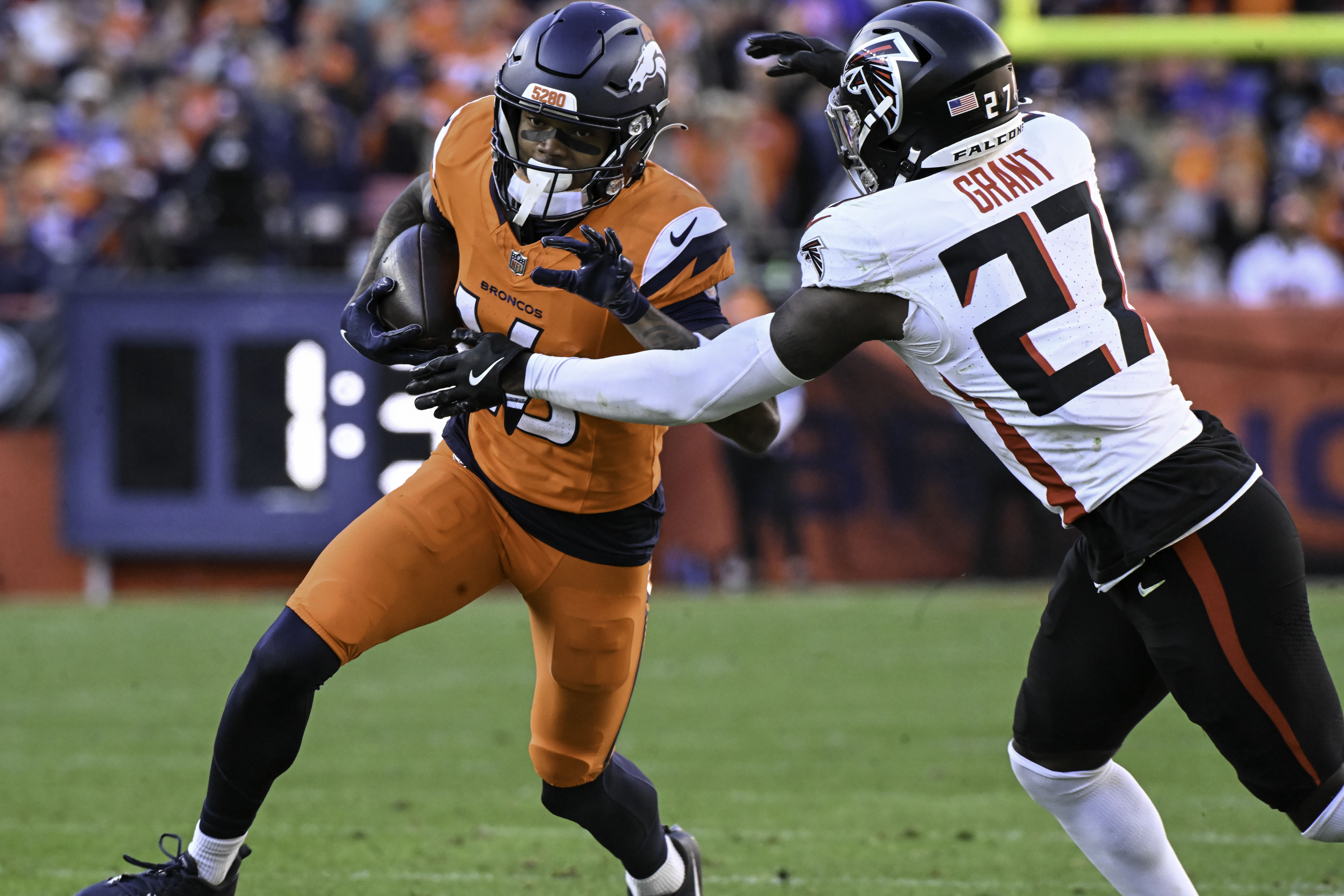 Denver Broncos wide receiver Troy Franklin (16) is pursued by Atlanta Falcons safety Richie Grant (27) during the second quarter of a game at Empower Field at Mile High on Sunday, Nov. 17, 2024. The Broncos defeated the Falcons 38-6. (Jerilee Bennett,The Gazette)