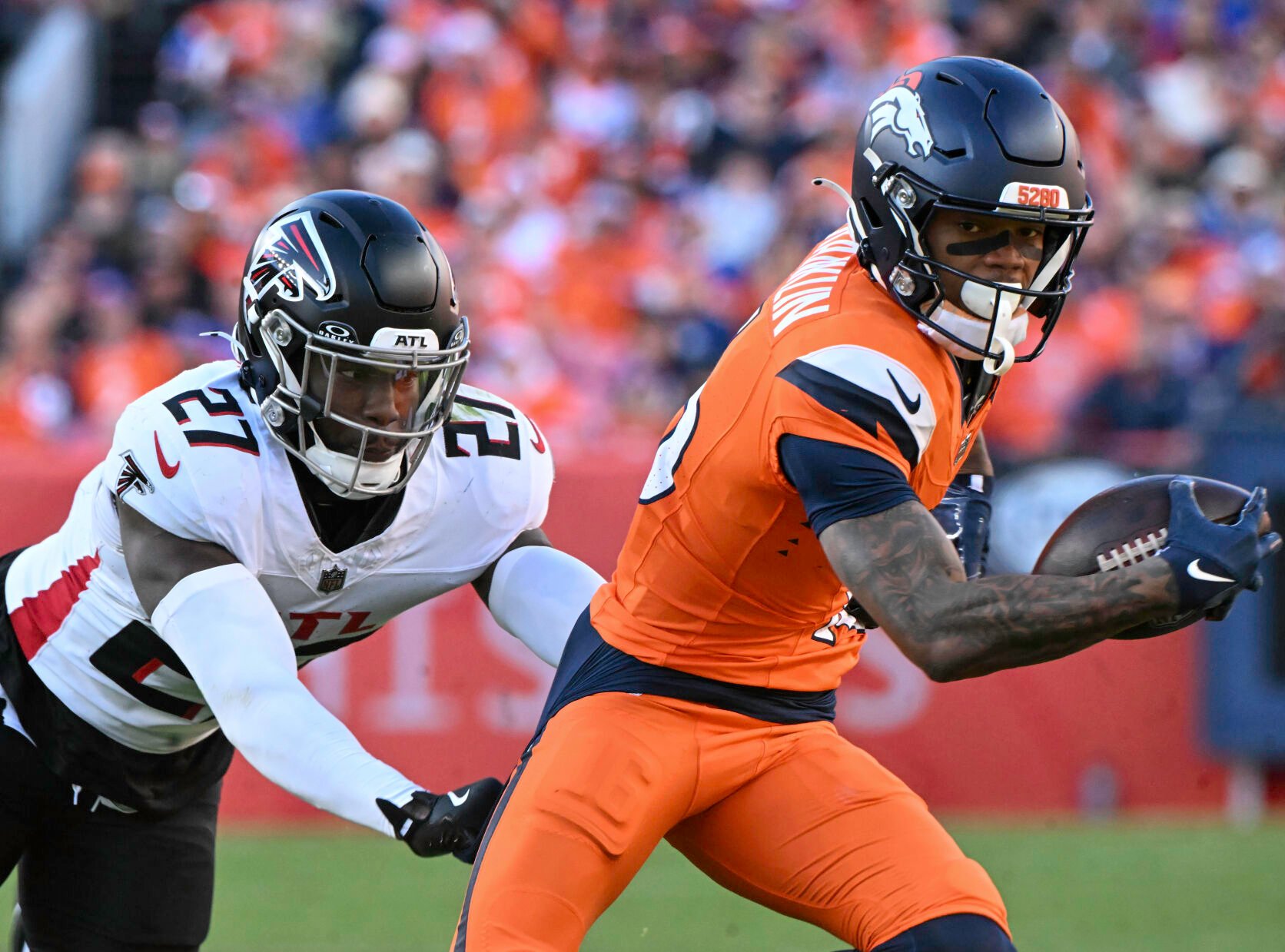 Denver Broncos wide receiver Troy Franklin (16) is pursued by Atlanta Falcons safety Richie Grant (27) during the second quarter of a game at Empower Field at Mile High on Sunday, Nov. 17, 2024. The Broncos defeated the Falcons 38-6. (Jerilee Bennett,The Gazette)