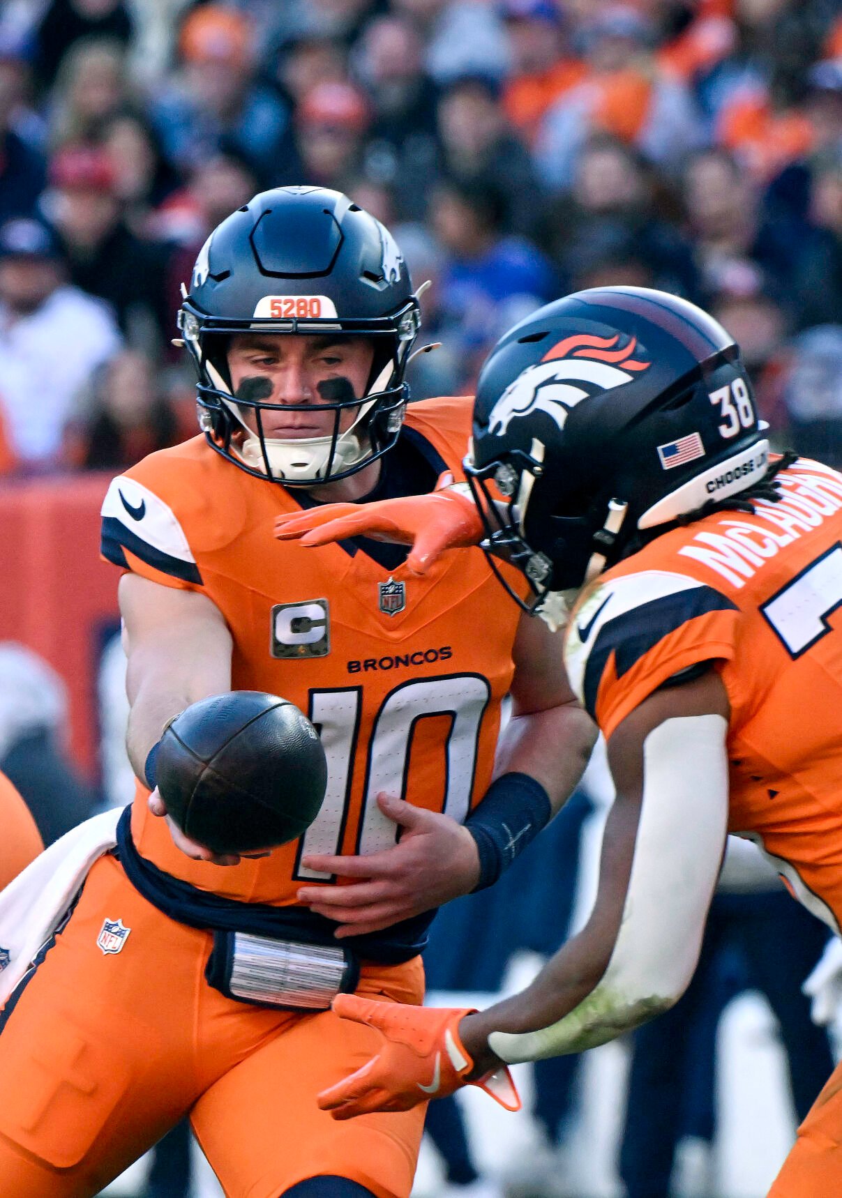 Denver Broncos quarterback Bo Nix (10) hands off the ball to Denver Broncos running back Jaleel McLaughlin (38) during the first quarter of a game at Empower Field at Mile High on Sunday, Nov. 17, 2024. The Broncos defeated the Falcons 38-6. (Jerilee Bennett,The Gazette)