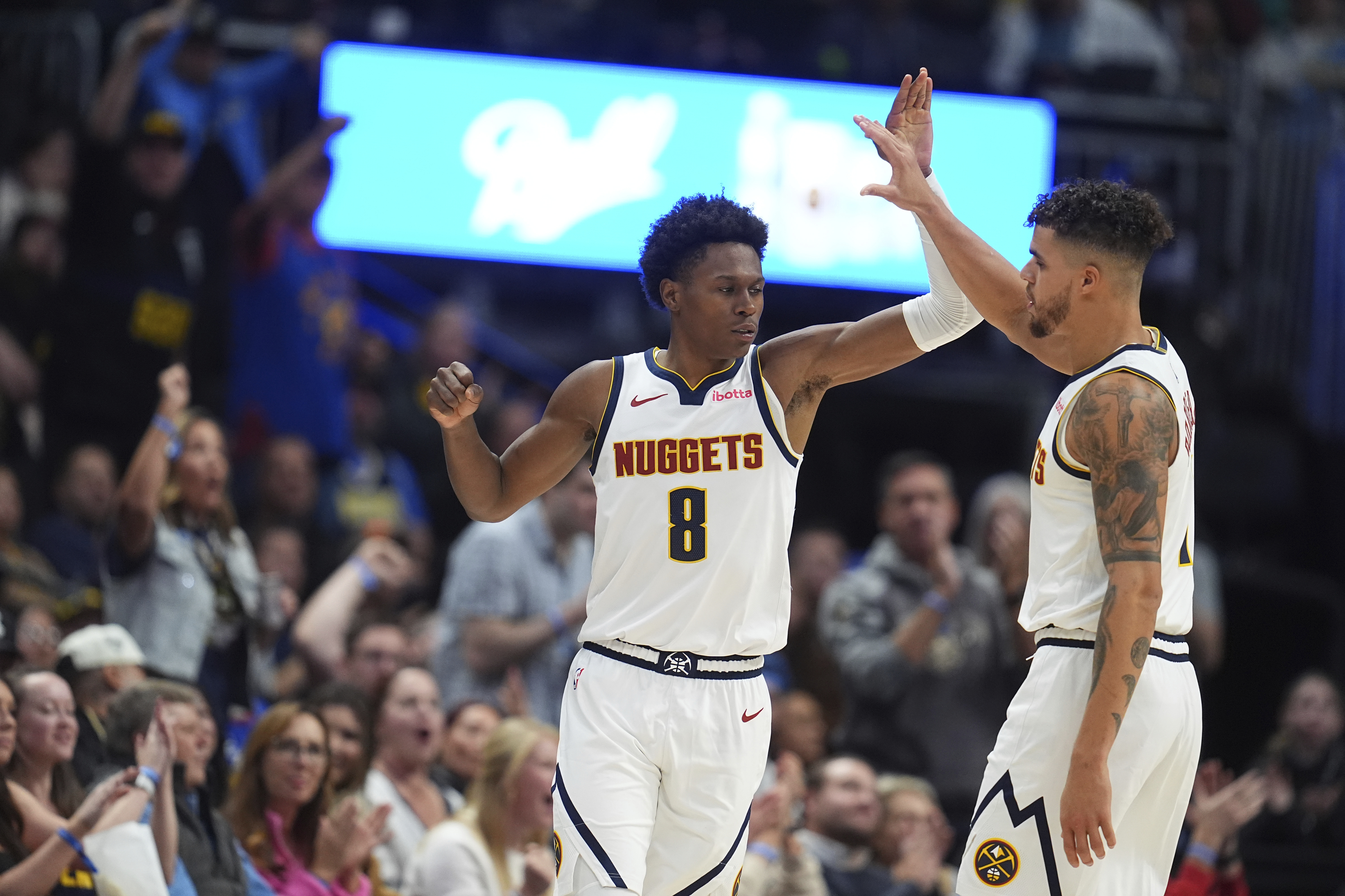 Denver Nuggets forward Peyton Watson, left, is congratulated after hitting a basket by forward Michael Porter Jr. in the second half of an NBA basketball game against the Toronto Raptors Monday, Nov. 4, 2024, in Denver. (AP Photo/David Zalubowski) (David Zalubowski)