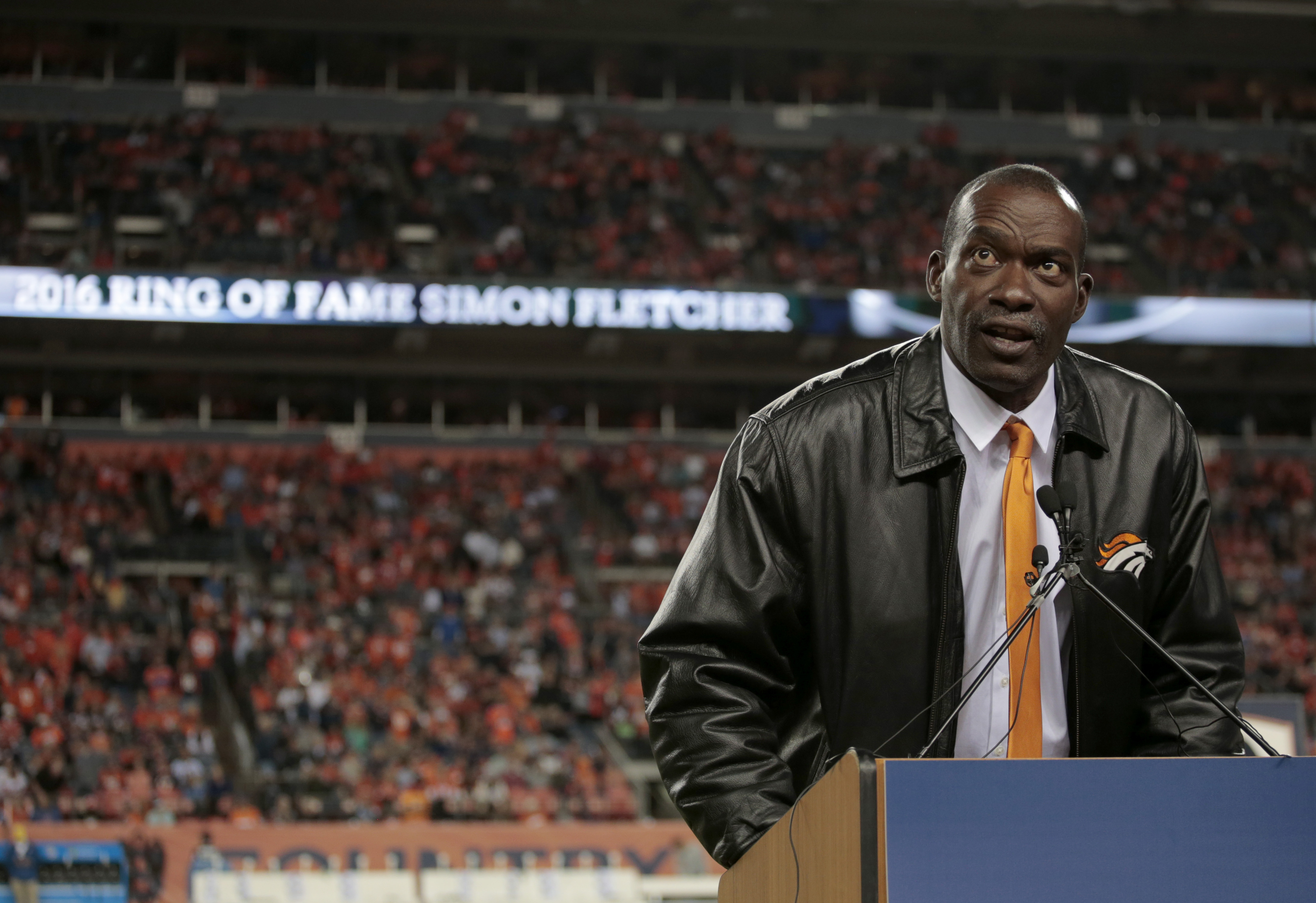 Former Denver Broncos' Simon Fletcher speaks after being inducted into the Broncos ring of honor at half time of an NFL football game against the Houston Texans, Monday, Oct. 24, 2016, in Denver. (AP Photo/Joe Mahoney) (Joe Mahoney)