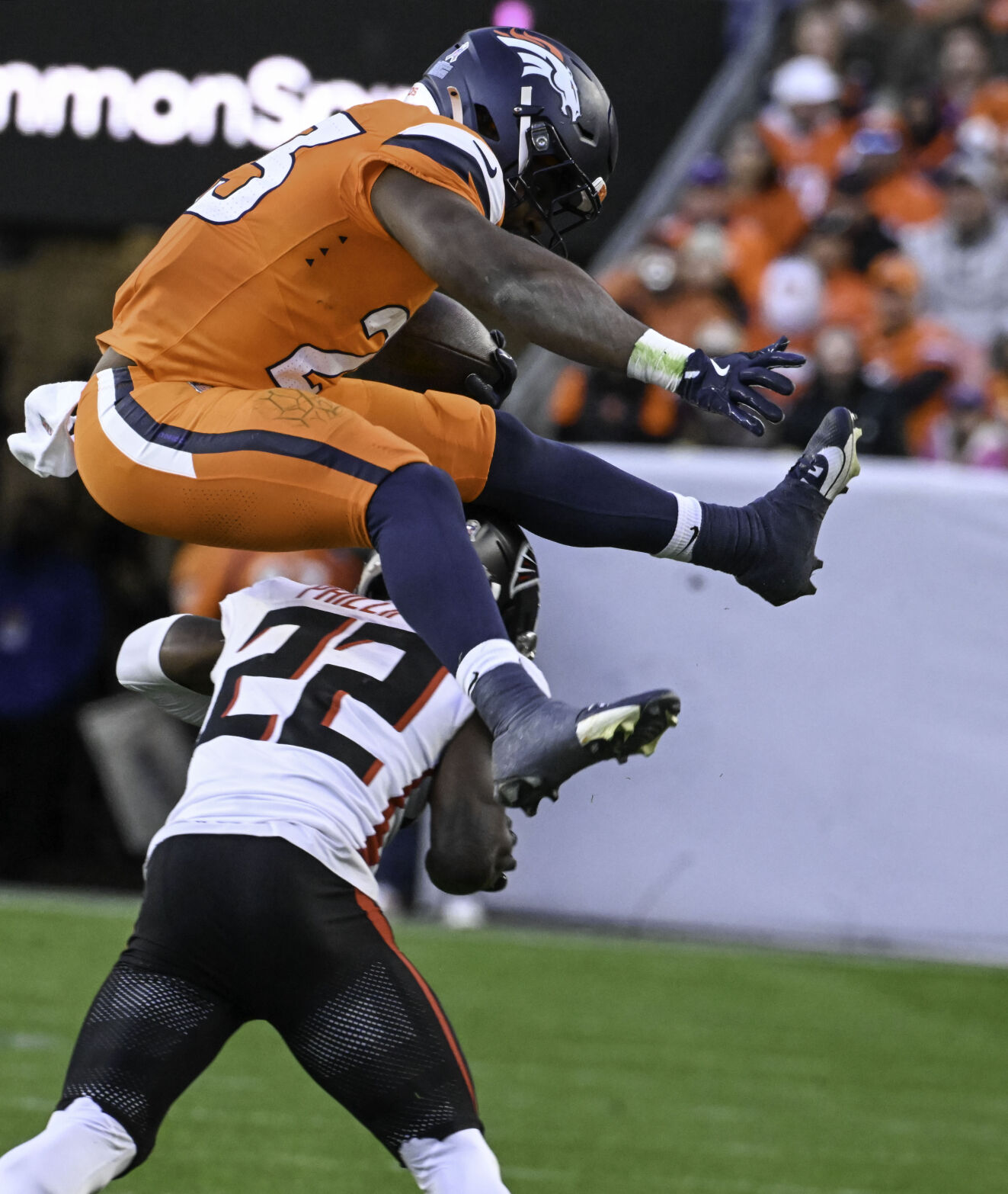 Denver Broncos running back Audric Estime (23) flies over Atlanta Falcons cornerback Clark Phillips III (22) during the third quarter of a game at Empower Field at Mile High on Sunday, Nov. 17, 2024. The Broncos defeated the Falcons 38-6. (Jerilee Bennett,The Gazette)
