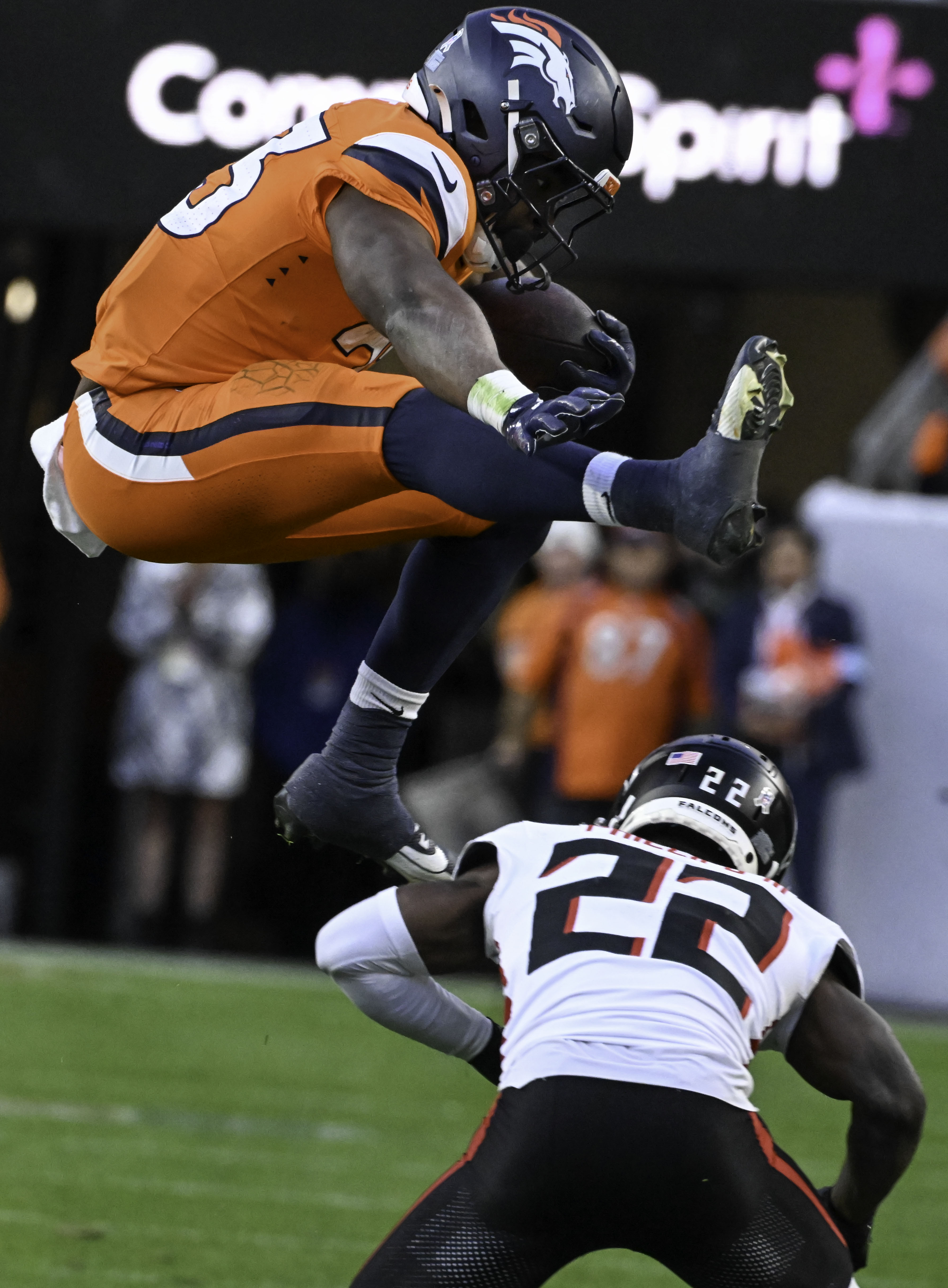 Denver Broncos running back Audric Estime (23) flies over Atlanta Falcons cornerback Clark Phillips III (22) during the third quarter of a game at Empower Field at Mile High on Sunday, Nov. 17, 2024. The Broncos defeated the Falcons 38-6. (Jerilee Bennett,The Gazette)