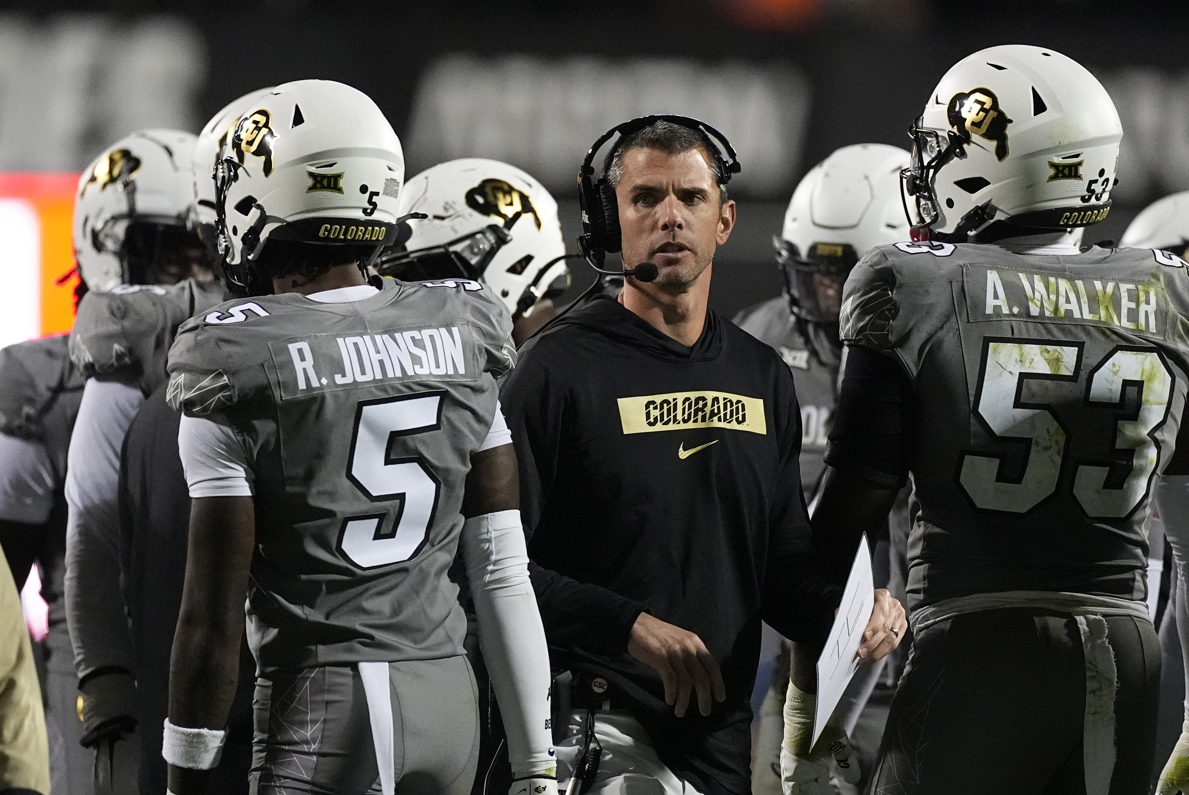 Colorado defensive coordinator Robert Livingston gives instructions to his unit during the second half of a game on Oct. 26 in Boulder. (The Associated Press)