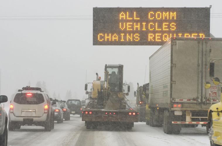 Truck traffic on I-70 highway with blizzard snow chains required (copy)