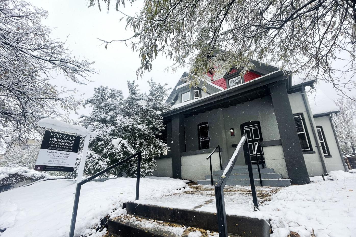 A house sits with a for sale sign in its yard in Denver's Capitol Hill