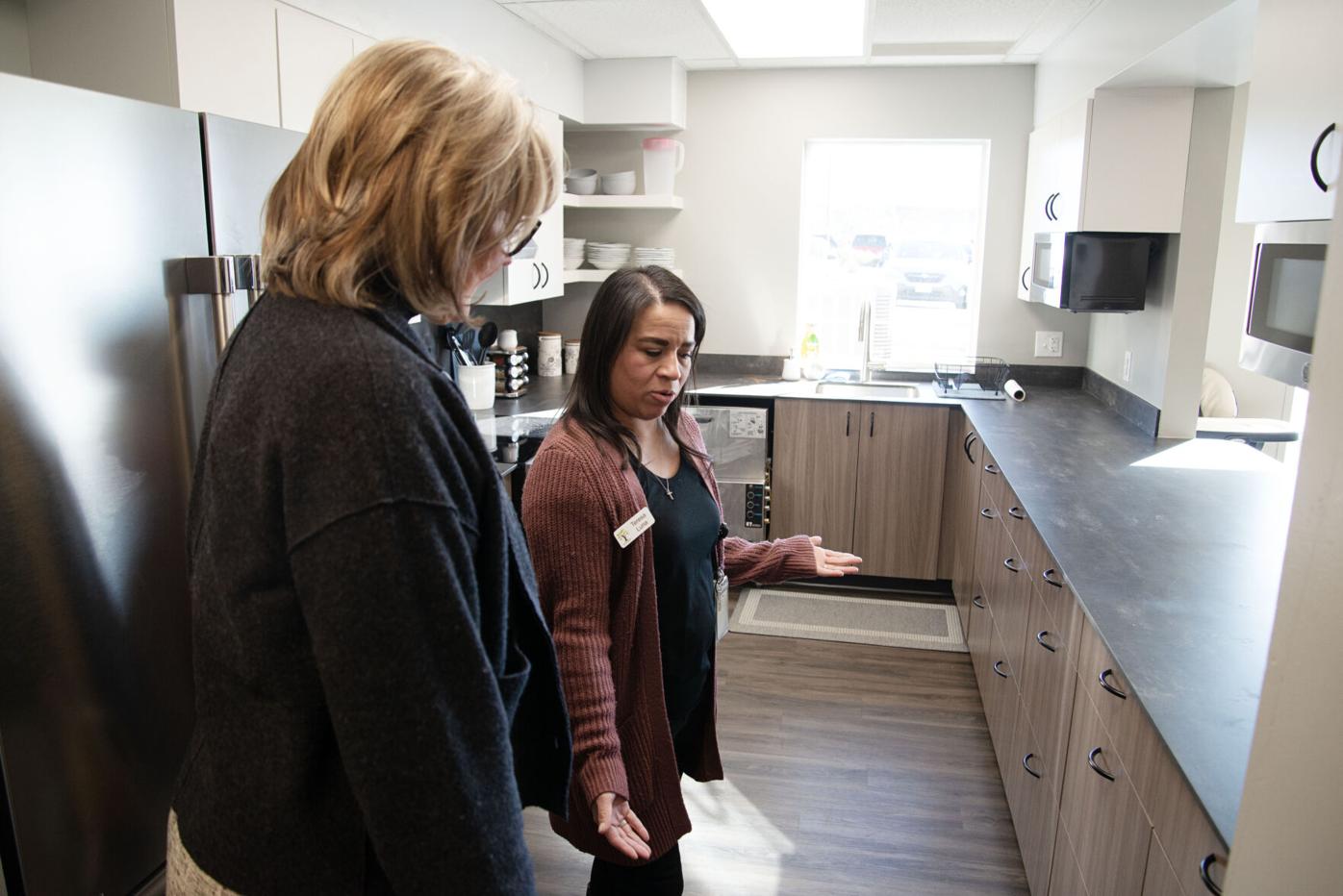 Teresa Luna, right, shows Araphoe County Commissioner, Carrie Warren-Gully,