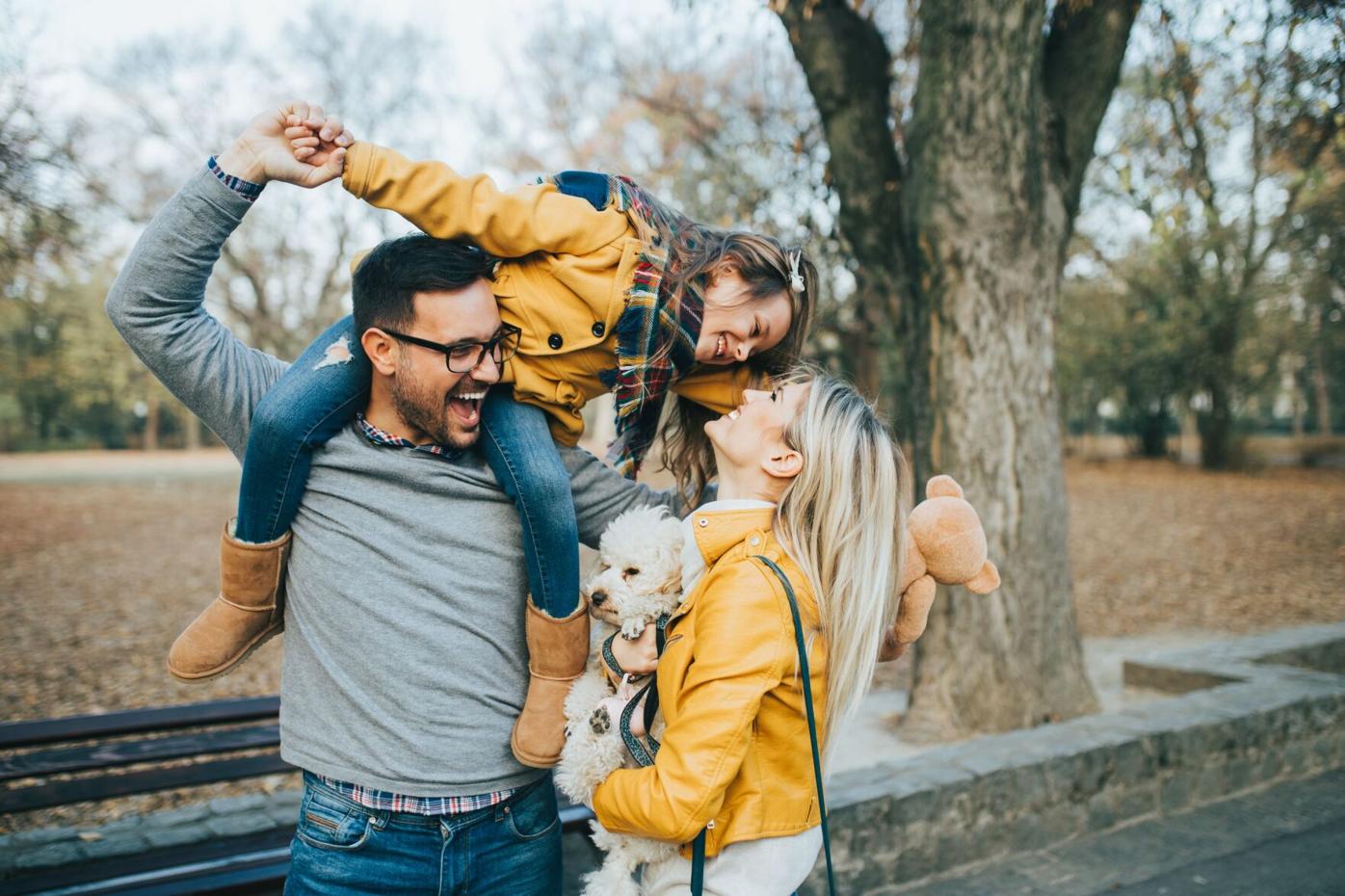 Family of three and dog in park resized