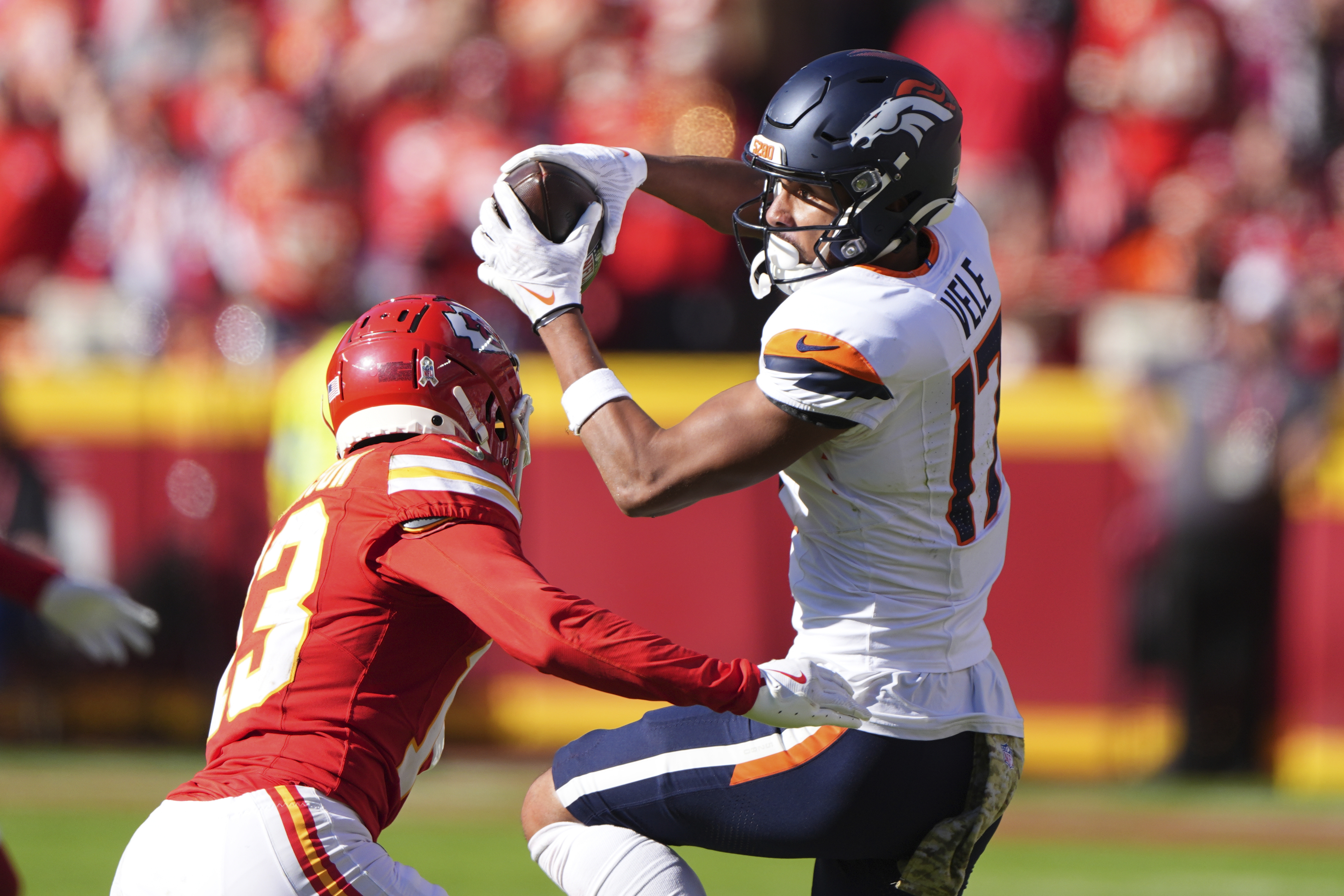Denver Broncos wide receiver Devaughn Vele (17) catches a pass as Kansas City Chiefs safety Nazeeh Johnson (13) defends during the first half of an NFL football game Sunday, Nov. 10, 2024, in Kansas City, Mo. (AP Photo/Charlie Riedel) (Charlie Riedel)