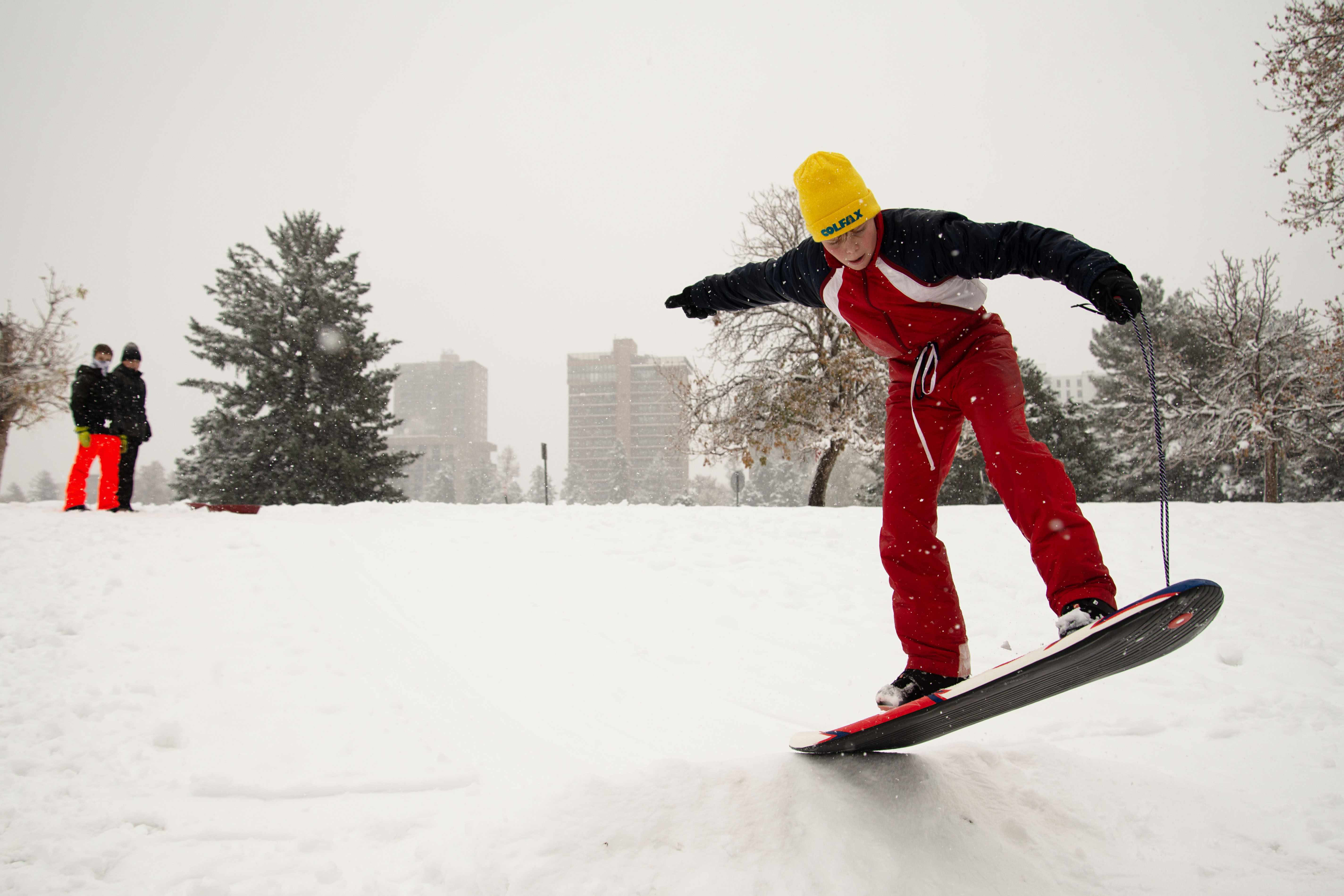 Case Cochran snowboards over a jump built by him and his friends, Franklin Weber, back left, and Grant Roesler while the trio have a snow day in Denver's Capitol Hill neighborhood on Friday, Nov. 8, 2024. (TomHellauerMultimedia Producertom.hellauer@denvergazette.comhttps://denvergazette.com/content/tncms/avatars/f/9e/622/f9e6228a-3b6b-11ed-bf10-fbb71fa8e421.f54b911252c540f1d61709edc4727a39.png)