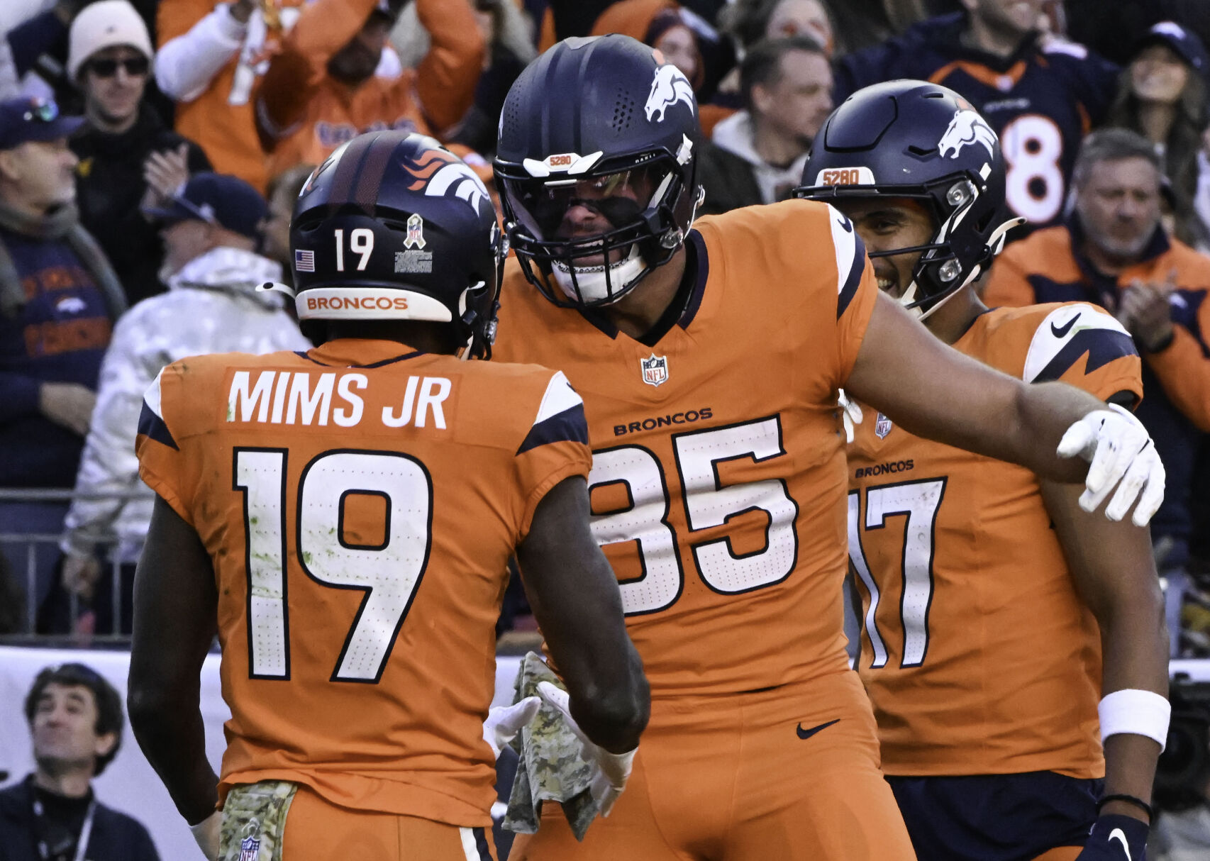 Denver Broncos tight end Lucas Krull (85) celebrates with Denver Broncos wide receiver Marvin Mims Jr. (19) after Mims scored a touchdown during a game against the Falcons at Empower Field at Mile High on Sunday, Nov. 17, 2024. (Jerilee Bennett,The Gazette)