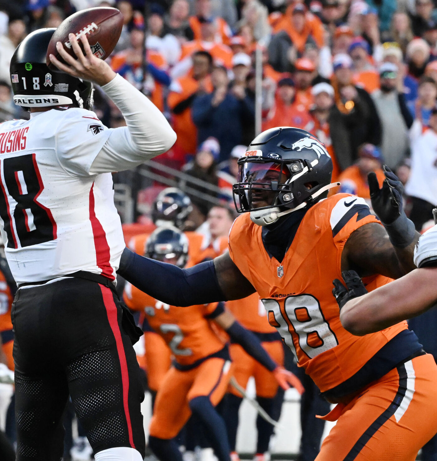 Denver Broncos defensive end John Franklin-Myers (98) pressures Atlanta Falcons quarterback Kirk Cousins (18) during a game against the Falcons at Empower Field at Mile High on Sunday, Nov. 17, 2024. (Jerilee Bennett,The Gazette)