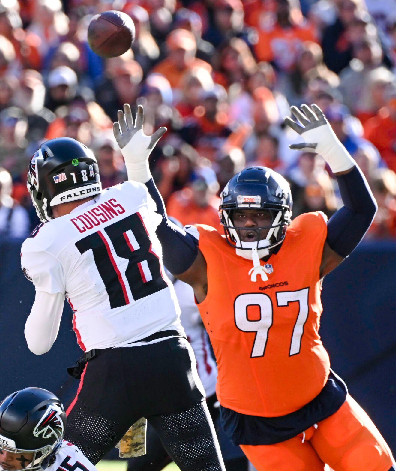 Atlanta Falcons quarterback Kirk Cousins (18) is pressured by Denver Broncos defensive tackle Malcolm Roach (97) during the first quarter of a game at Empower Field at Mile High on Sunday, Nov. 17, 2024. The Broncos defeated the Falcons 38-6. (Jerilee Bennett,The Gazette)