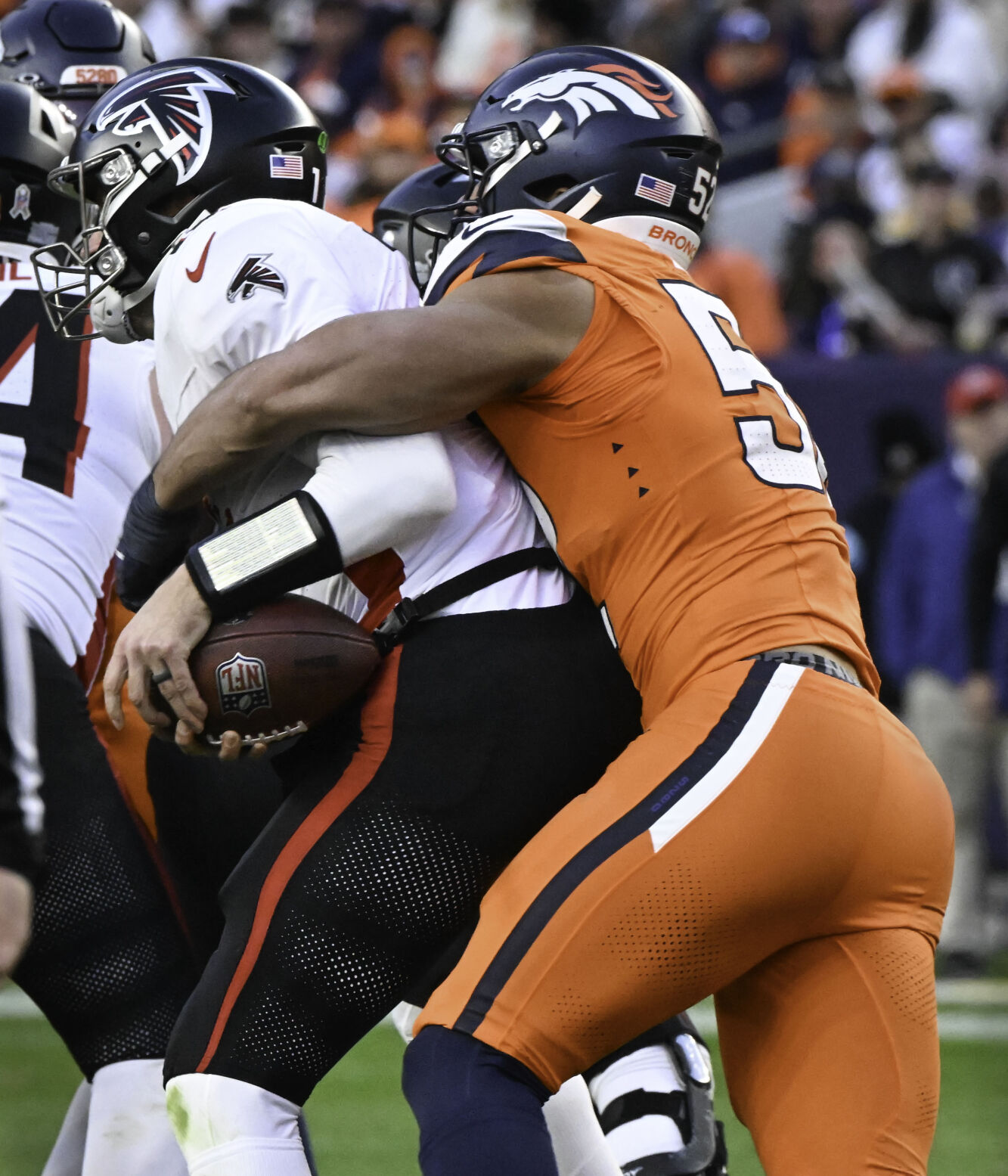 Denver Broncos linebacker Jonah Elliss (52) sacks Atlanta quarterback Kirk Cousins during the fourth quarter of a game at Empower Field at Mile High on Sunday, Nov. 17, 2024. The Broncos defeated the Falcons 38-6. (Jerilee Bennett,The Gazette)
