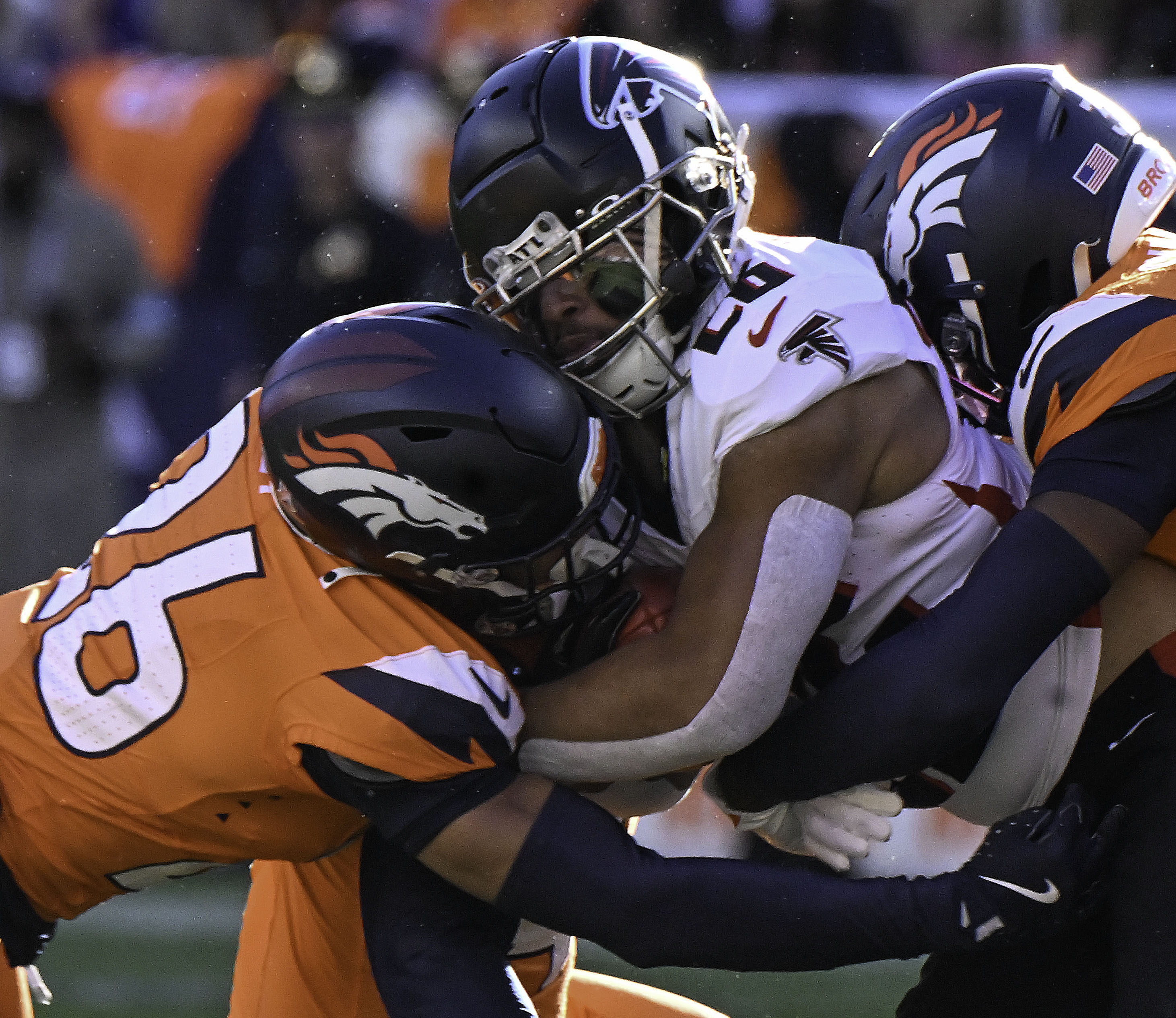 Denver Broncos safety Devon Key (26) tackles Atlanta Falcons running back Avery Williams (26) during a game against the Falcons at Empower Field at Mile High on Sunday, Nov. 17, 2024. (Jerilee Bennett,The Gazette)