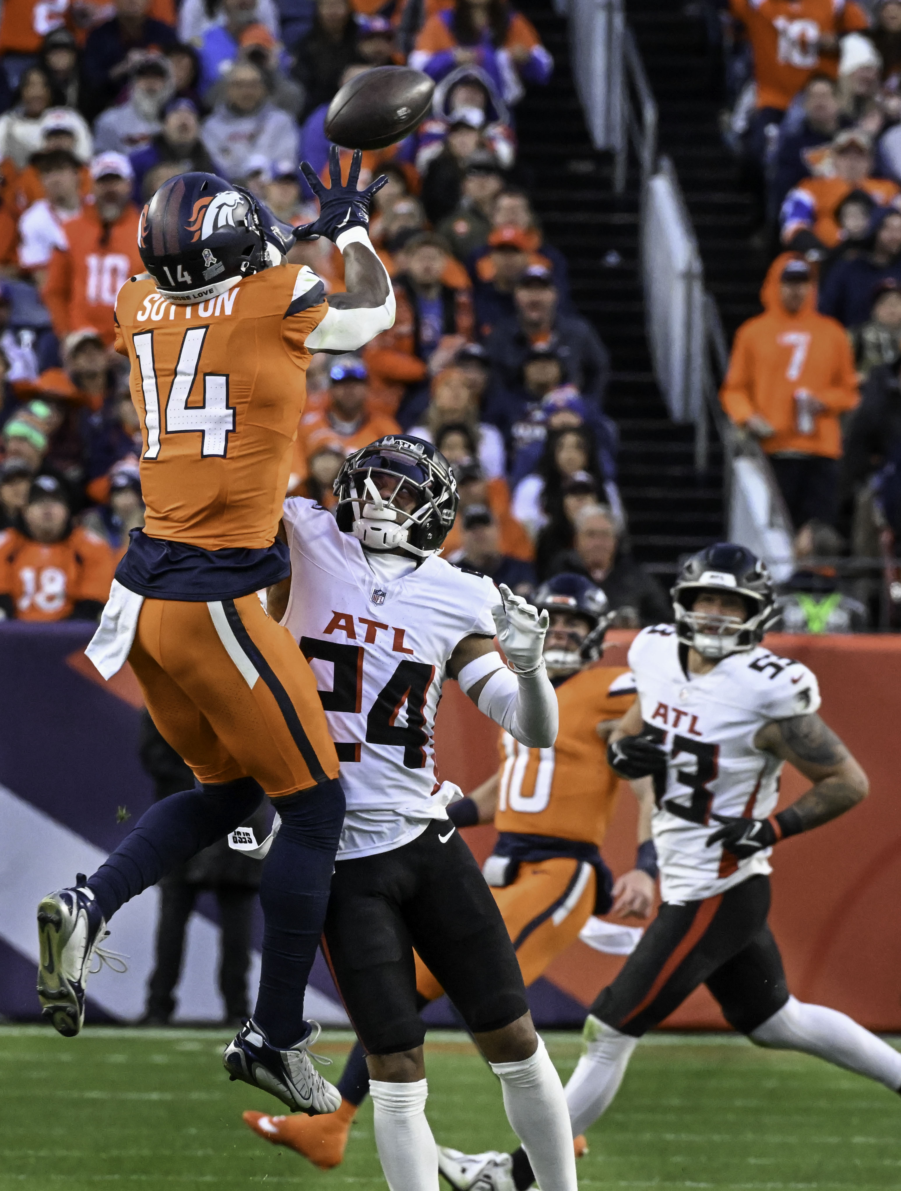 Denver Broncos wide receiver Courtland Sutton (14) goes up for a catch over Atlanta Falcons cornerback A.J. Terrell (24) for a gain of 23 yards during the fourth quarter of a game at Empower Field at Mile High on Sunday, Nov. 17, 2024. The Broncos defeated the Falcons 38-6. (Jerilee Bennett,The Gazette)