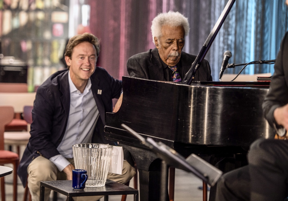 Denver Mayor Mike Johnston sits with Purnell Steen as the jazz legend played at the launch of Denver Arts Week at Dazzle on Nov. 1, 2024, (JOHN MOORE, DENVER GAZETTE)
