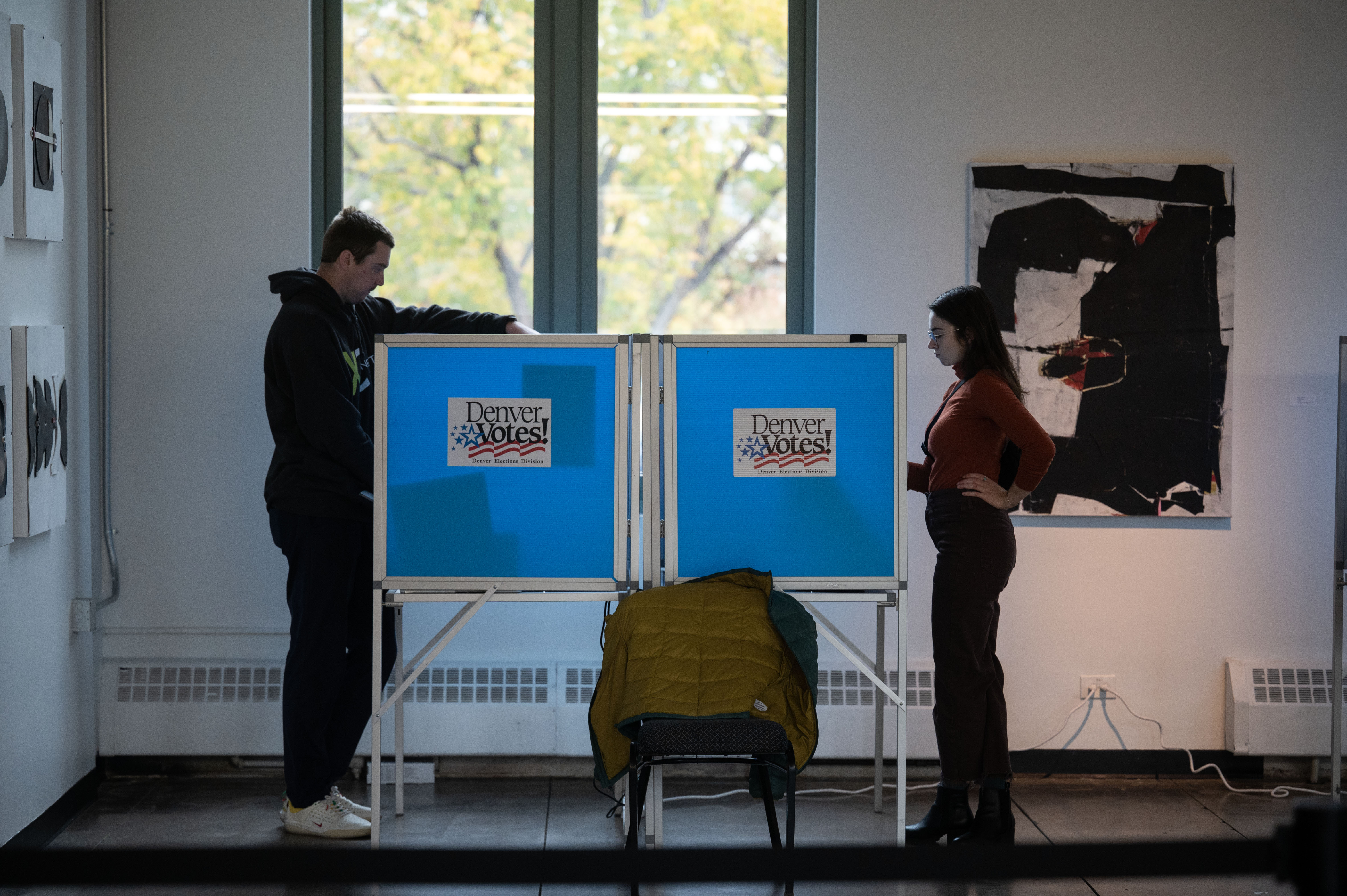 Sean Flaherty, left, and Kelly Giuliani fill out their ballots at a polling center in the McNichols building in Denver on Monday, Nov. 4, 2024. (Stephen Swofford, Denver Gazette) (Stephen Swofford Denver Gazette)